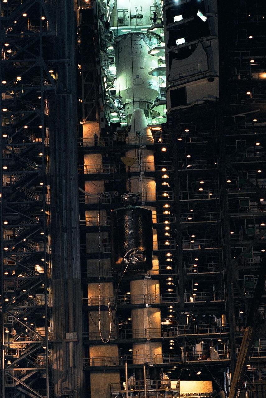 Technicians at Launch Complex 40, Cape Canaveral Air Station (CCAS), connect the crane to the top of the Cassini spacecraft in preparation for the lift to the top of its Titan IV/Centaur launch vehicle. Cassini is an international mission conducted by the National Aeronautics and Space Administration (NASA), the European Space Agency (ESA), and the Italian Space Agency (ASI). The two-story-tall spacecraft, scheduled for launch on Oct. 6, is destined to arrive at Saturn in July 2004, where it will orbit and study Saturn, its rings, moons and magnetic environment in detail over a four-year period. The Cassini mission is managed for NASA's Office of Space Science by the Jet Propulsion Laboratory, a division of the California Institute of Technology