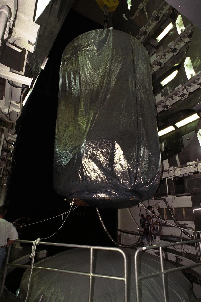 The Cassini spacecraft is lowered to the top of its Titan IV/Centaur launch vehicle at Launch Complex 40, Cape Canaveral Air Station (CCAS). Cassini is an international mission conducted by the National Aeronautics and Space Administration (NASA), the European Space Agency (ESA), and the Italian Space Agency (ASI). The two-story-tall spacecraft, scheduled for launch on Oct. 6, is destined to arrive at Saturn in July 2004, where it will orbit and study Saturn, its rings, moons and magnetic environment in detail over a four-year period. The Cassini mission is managed for NASA's Office of Space Science by the Jet Propulsion Laboratory, a division of the California Institute of Technology