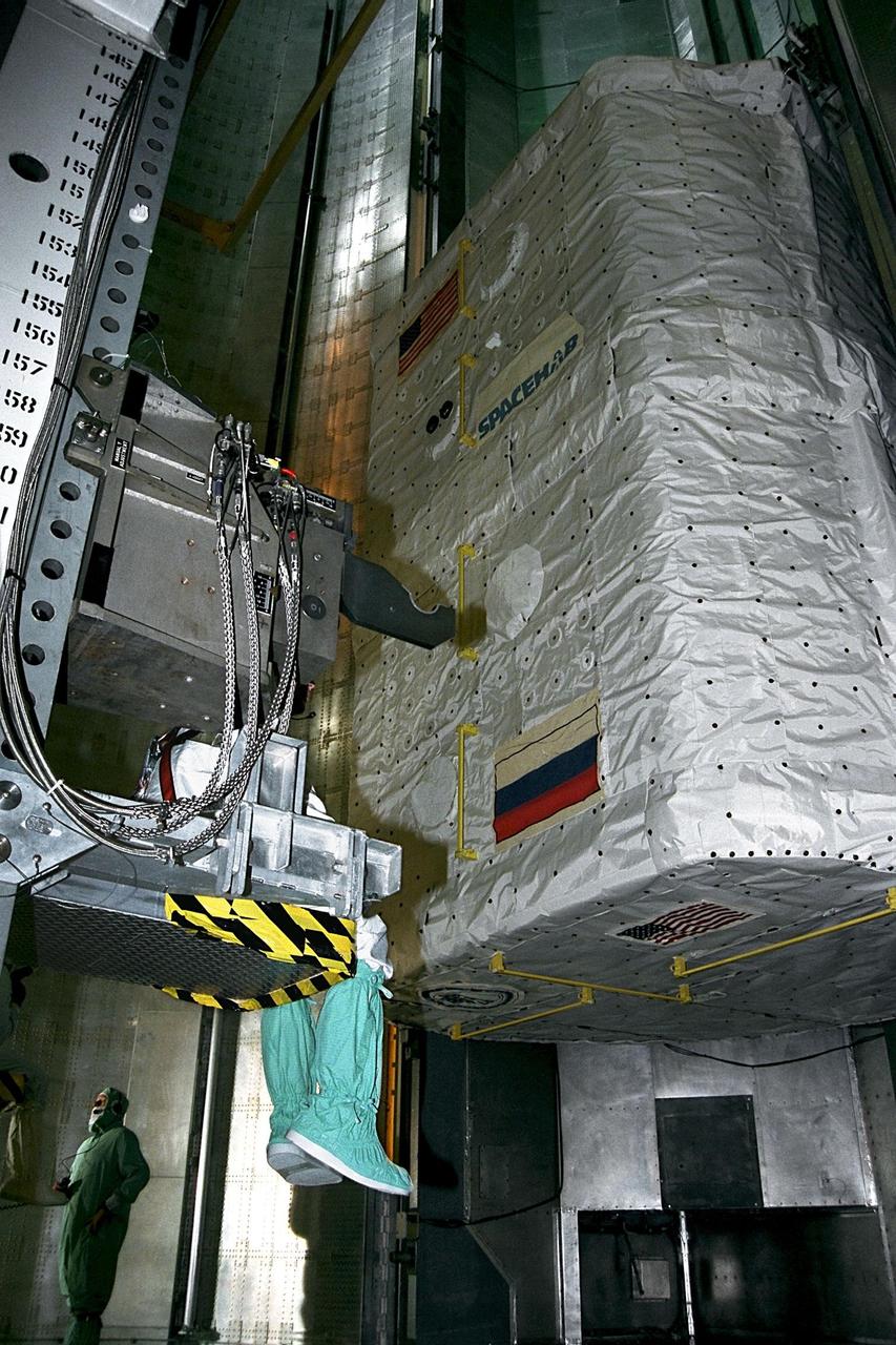 KENNEDY SPACE CENTER, FLA. -- The SPACEHAB Double Module is lifted into the Payload Changeout Room at Launch Pad 39A for insertion into the payload bay of the Space Shuttle Atlantis. SPACEHAB will be used to transport items to and from the Russian Space Shuttle Mir on Mission STS-86, which will be the seventh docking of the Shuttle with the Mir. About three-and-a-half tons of science/logistical equipment and supplies will be exchanged between Atlantis and the Mir during the mission. STS-86 Mission Specialist David A. Wolf will transfer to the Russian space station, replacing NASA astronaut and Mir 24 crew member C. Michael Foale, who will return to Earth on Atlantis. Liftoff is targeted for Sept. 25