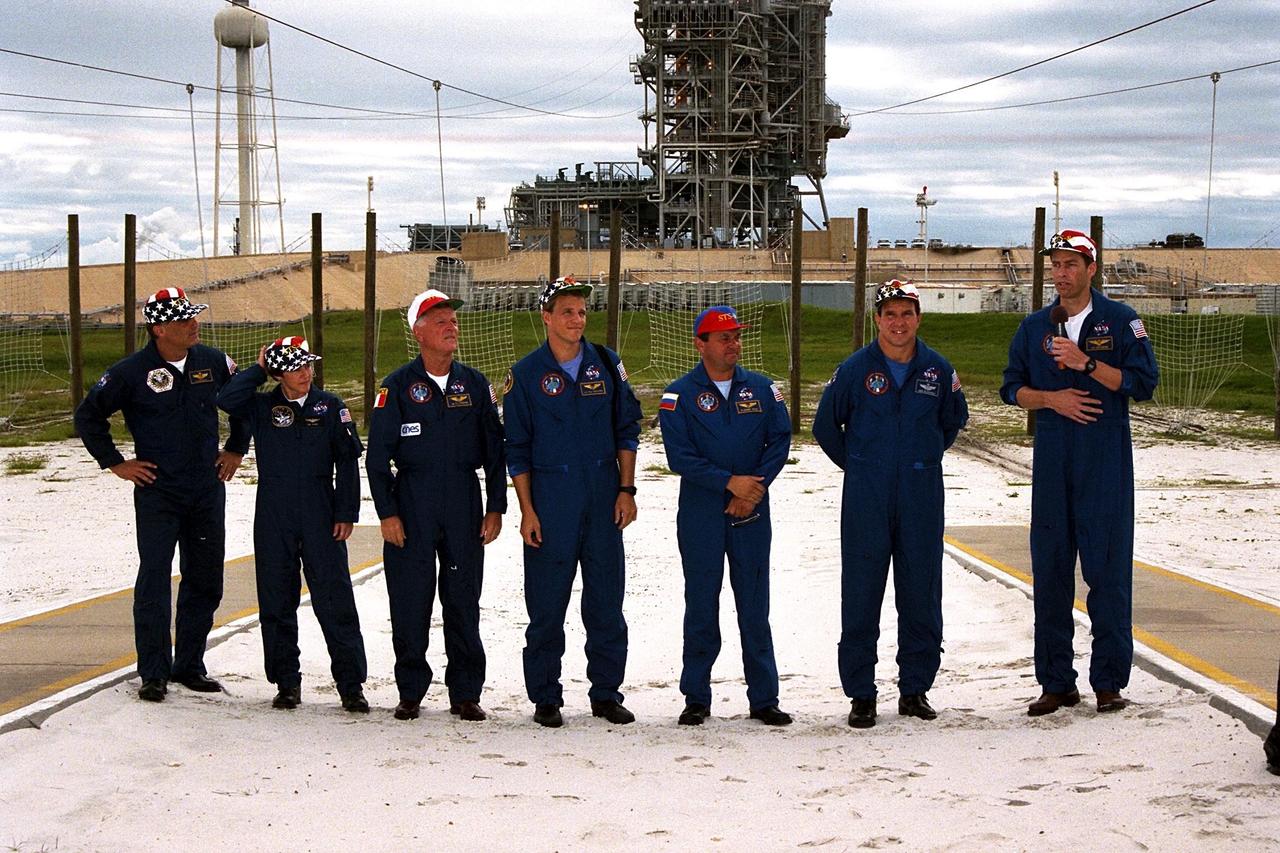 KENNEDY SPACE CENTER, Fla. -- STS-86 Commander James D. Wetherbee, with microphone, and other crew members of the Space Shuttle Atlantis speak to media representatives and other onlookers at Launch Pad 39A during the Terminal Countdown Demonstration Test (TCDT), a dress rehearsal for launch. From right, after Wetherbee, are Pilot Michael J. Bloomfield, Mission Specialist Vladimir Georgievich Titov of the Russian Space Agency, Mission Specialist Scott E. Parazynski, Mission Specialist Jean-Loup J.M. Chretien of the French Space Agency, CNES, and Mission Specialists Wendy B. Lawrence and David A. Wolf. STS-86 will be the seventh docking of the Space Shuttle with the Russian Space Station Mir. During the docking, Wolf will transfer to the orbiting Russian station and become a member of the Mir 24 crew, replacing U.S. astronaut C. Michael Foale, who has been on the Mir since the last docking mission, STS-84, in May. Launch of Mission STS-86 aboard the Space Shuttle Atlantis is targeted for Sept. 25
