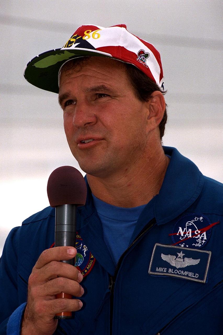 KENNEDY SPACE CENTER, Fla. -- STS-86 Pilot Michael J. Bloomfield speaks to media representatives and other onlookers during Terminal Countdown Demonstration Test (TCDT) activities at Launch Pad 39A. This will be his first spaceflight. STS-86 will be the seventh docking of the Space Shuttle with the Russian Space Station Mir. During the docking, STS-86 Mission Specialist David A. Wolf will transfer to the orbiting Russian station and become a member of the Mir 24 crew, replacing U.S. astronaut C. Michael Foale, who has been on the Mir since the last docking mission, STS-84, in May. Launch of Mission STS-86 aboard the Space Shuttle Atlantis is targeted for Sept. 25