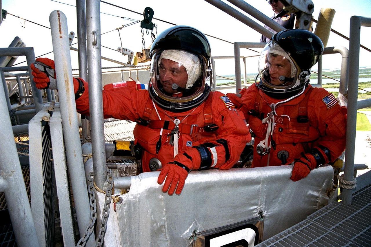 KENNEDY SPACE CENTER, Fla. -- STS-86 Mission Specialists Vladimir Georgievich Titov of the Russian Space Agency, at left, and Scott E. Parazynski practice emergency egress procedures in a slidewire basket as part of Terminal Countdown Demonstration Test (TCDT) activities at Launch Pad 39A. Titov and Parazynski are scheduled to perform a spacewalk during the STS-86 mission, which will be the seventh docking of the Space Shuttle with the Russian Space Station Mir. Liftoff of the Space Shuttle Atlantis on Mission STS-86 is targeted for Sept. 25