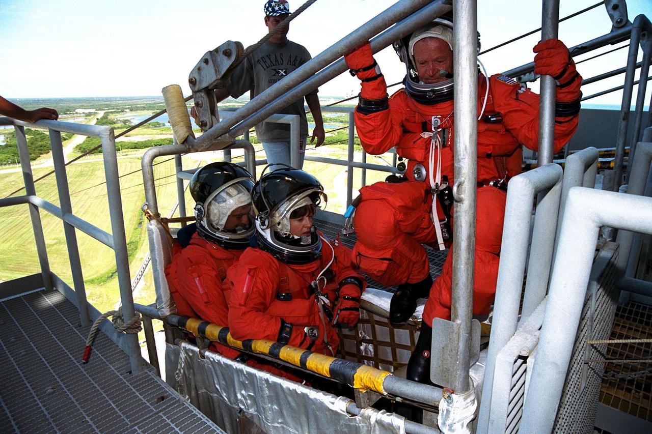 KENNEDY SPACE CENTER, Fla. -- STS-86 Mission Specialist Jean-Loup J.M. Chretien of the French Space Agency, CNES, prepares to join his fellow crew members, Mission Specialists Wendy B. Lawrence and David A. Wolf, at far left, in a slidewire basket during emergency egress training at Launch Pad 39A. The crew is at KSC to participate in the Terminal Countdown Demonstration Test (TCDT), a dress rehearsal for launch. STS-86 will be the seventh docking of the Space Shuttle with the Russian Space Station Mir. Liftoff of the Space Shuttle Atlantis on Mission STS-86 is targeted for Sept. 25