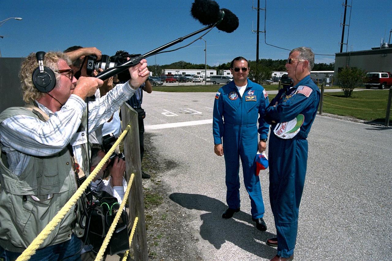 KENNEDY SPACE CENTER, Fla. -- STS-86 Mission Specialists Vladimir Georgievich Titov, at left, and Jean-Loup J.M. Chretien, the two members of the STS-86 crew representing foreign space agencies, talk to press representatives before departing from KSC’s Shuttle Landing Facility. They and the five other crew members were at KSC to participate in the Terminal Countdown Demonstration Test (TCDT). They will return to Johnson Space Center, Houston, Texas, for final prelaunch training. Titov is a cosmonaut with the Russian Space Agency; Chretien is an astronaut with the French Space Agency, CNES. Titov will make his fifth spaceflight, and second on the Space Shuttle, on STS-86 aboard Atlantis. Chretien has flown twice before as a research-cosmonaut on Russian missions; this will be his first Shuttle mission. STS-86 will be the seventh docking of the Space Shuttle with the Russian Space Station Mir. Liftoff is targeted for Sept. 25 from Launch Pad 39A