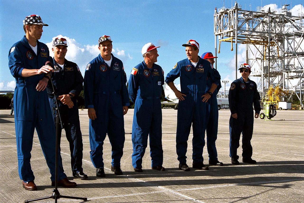 STS-86 Commander James D. Wetherbee, with microphone, addresses press representatives and other onlookers after the astronauts’ arrival Monday at KSC’s Shuttle Landing Facility. The other crew members, from left, are Mission Specialist David A. Wolf; Pilot Michael J. Bloomfield; Mission Specialist Jean-Loup J.M. Chretien of the French Space Agency, CNES; Mission Specialist Scott E. Parazynksi; Mission Specialist Vladimir Georgievich Titov of the Russian Space Agency; and Mission Specialist Wendy B. Lawrence. STS-86 is slated to be the seventh docking of the Space Shuttle with the Russian Space Station Mir. After the docking, Wolf is scheduled to transfer to the Mir 24 crew, replacing astronaut C. Michael Foale. Wolf is scheduled to remain on the Mir for about four months. Liftoff of STS-86 aboard Atlantis is targeted for Sept. 25