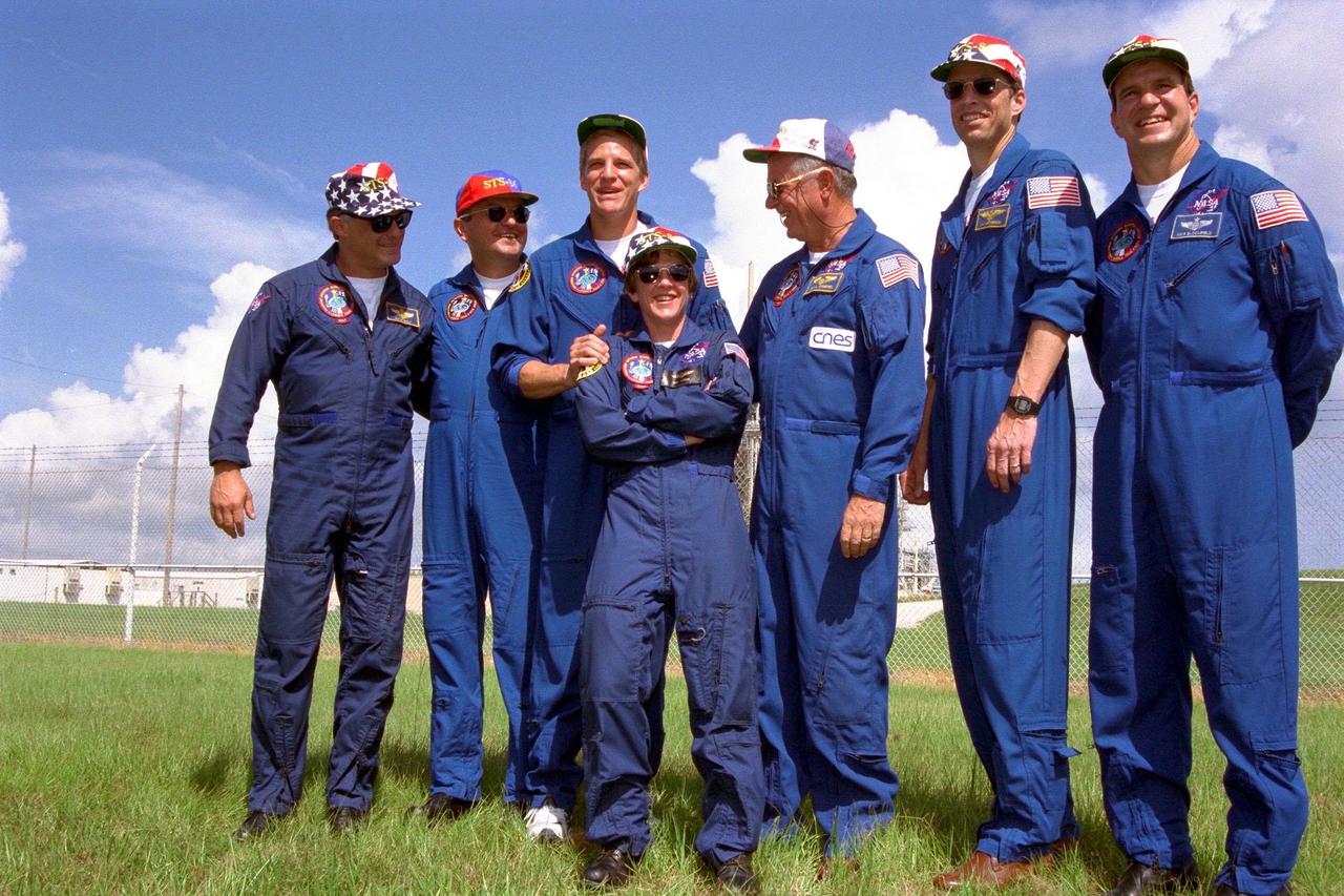 The STS-86 crew enjoys a relaxing moment while greeting friends, families and other well-wishers the day before the scheduled Sept. 25 launch aboard the Space Shuttle Atlantis. From left are Mission Specialist David A. Wolf; Mission Specialist Vladimir Georgievich Titov of the Russian Space Agency; Mission Specialist Scott E. Parazynski; Mission Specialist Wendy B. Lawrence (leaning into Parazynski); Mission Specialist Jean-Loup J.M. Chretien of the French Space Agency, CNES; Commander James D. Wetherbee; and Pilot Michael J. Bloomfield. STS-86 is slated to be the seventh docking of the Space Shuttle and the Russian Space Station Mir. Parazynski and Lawrence had trained to live and work aboard the Russian station but were withdrawn from Mir training Parazynski because he was "too tall" to fit safely in the Russian Soyuz vehicle, and Lawrence because she is "too short" to fit in the Russian spacewalk suit. "Just right" Wolf is scheduled to become a Mir 24 crew member after the docking, to replace U.S. astronaut C. Michael Foale for an extended stay aboard the Russian orbiting outpost