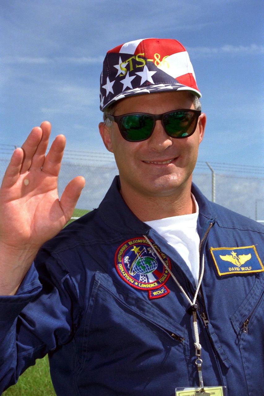 STS-86 Mission Specialist David A. Wolf waves to family members, friends and other well-wishers during a brief visit to Launch Pad 39A the day before the scheduled Sept. 25 launch aboard the Space Shuttle Atlantis. STS-86 is slated to be the seventh docking of the Space Shuttle with the Russian Space Station Mir. Wolf will be making his second spaceflight. After the docking, Wolf is scheduled to become a member of the Mir 24 crew, replacing U.S. astronaut C. Michael Foale. Wolf would remain on the Mir for about four months. Foale, who has been on the Mir since the STS-84 mission in mid-May, will return to Earth with the remaining six members of the STS-86 crew at the end of the planned 10-day flight