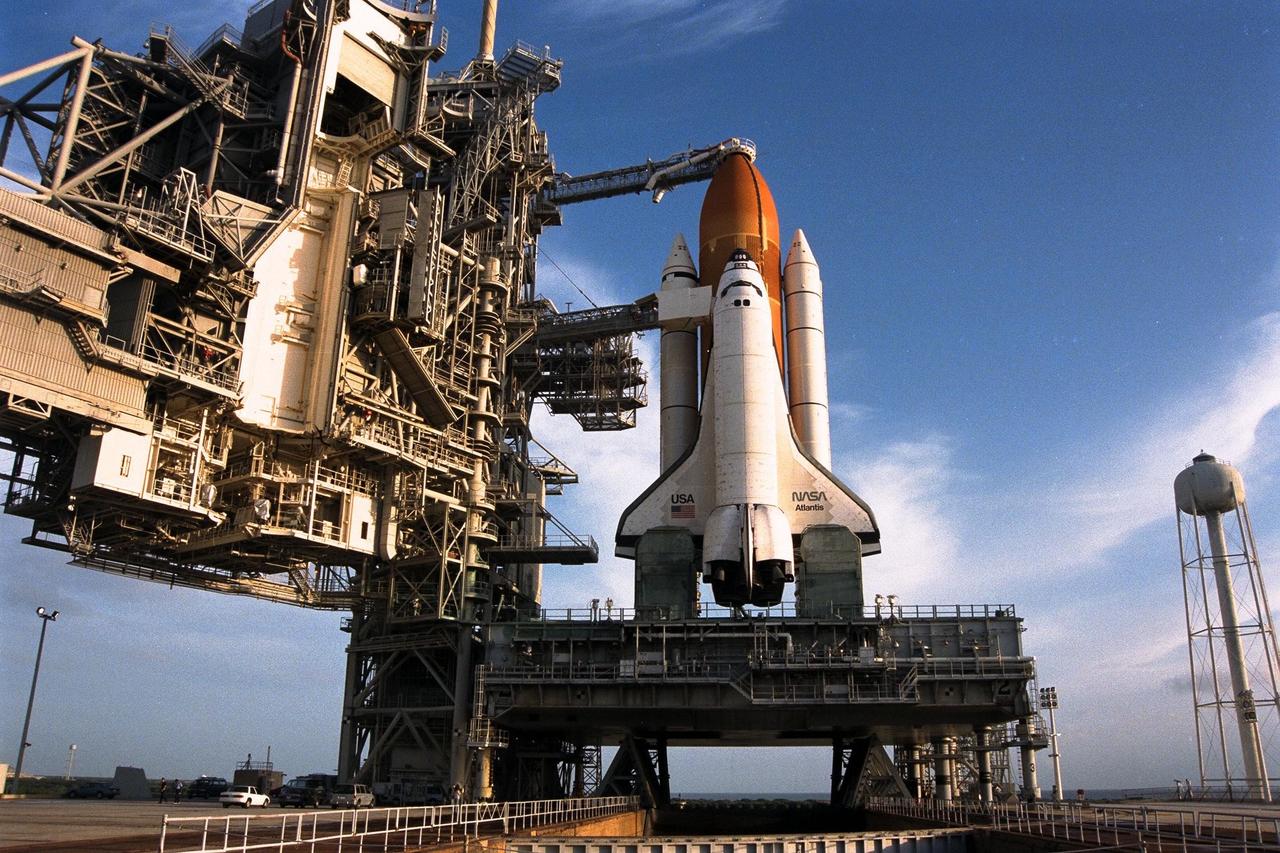 With the Rotating Service Structure rolled back, at left, the Space Shuttle Atlantis undergoes final prelaunch preparations at Launch Pad 39A for the STS-86 mission. One of the final steps will be to load the external tank with approximately 500,000 gallons of liquid hydrogen and liquid oxygen for fueling the orbiter’s three main engines. STS-86 is slated to be the seventh docking of the Space Shuttle with the Russian Space Station Mir. Liftoff is targeted for Sept. 25 at 10:34 p.m. EDT during a preferred launch window which lasts six minutes and 45 seconds. Seven crew members will lift off for the scheduled 10-day flight. One of those crew members, David A. Wolf, will transfer to the Mir for an approximate four-month stay. He will replace U.S. astronaut C. Michael Foale, who will return to Earth with the remainder of the STS86 crew. Foale has been on the Russian space station since mid-May