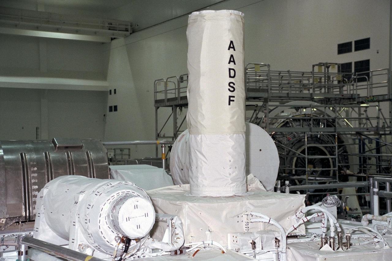 United States Microgravity Payload-4 (USMP-4) experiments are prepared to be flown on Space Shuttle mission STS-87 in the Space Station Processing Facility at Kennedy Space Center (KSC). The vertical tube in the center of the photo is the Advanced Automated Directional Solidification Furnace (AADSF), which will be used by researchers to study the solidification of semiconductor materials in microgravity. Scientists will be able to better understand how microgravity influences the solidification process of these materials and develop better methods for controlling that process during future Space flights and Earth-based production. To its left is MEPHISTO, the French acronym for a cooperative American-French investigation of the fundamentals of crystal growth. All STS-87 experiments are scheduled for launch on Nov. 19 from KSC