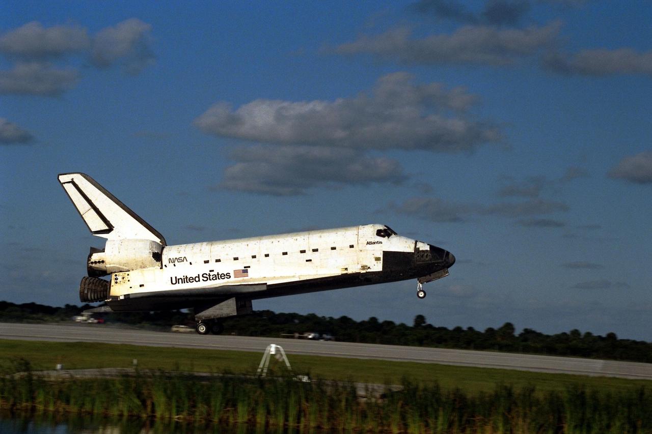 The Space Shuttle orbiter Atlantis touches down on Runway 15 of the KSC Shuttle Landing Facility (SLF) to complete the nearly 11-day STS-86 mission. Main gear touchdown was at 5:55:09 p.m. EDT on Oct. 6, 1997. The unofficial mission-elapsed time at main gear touchdown was 10 days, 19 hours, 20 minutes and 50 seconds. The first two landing opportunities on Sunday were waved off because of weather concerns. The 87th Space Shuttle mission was the 40th landing of the Shuttle at KSC. On Sunday evening, the Space Shuttle program reached a milestone: The total flight time of the Shuttle passed the two-year mark. STS-86 was the seventh of nine planned dockings of the Space Shuttle with the Russian Space Station Mir. STS-86 Mission Specialist David A. Wolf replaced NASA astronaut and Mir 24 crew member C. Michael Foale, who has been on the Mir since mid-May. Foale returned to Earth on Atlantis with the remainder of the STS-86 crew. The other crew members are Commander James D. Wetherbee, Pilot Michael J. Bloomfield, and Mission Specialists Wendy B. Lawrence, Scott E. Parazynski, Vladimir Georgievich Titov of the Russian Space Agency, and Jean-Loup J.M. Chretien of the French Space Agency, CNES. Wolf is scheduled to remain on the Mir until the STS-89 Shuttle mission in January. Besides the docking and crew exchange, STS-86 included the transfer of more than three-and-ahalf tons of science/logistical equipment and supplies between the two orbiting spacecraft. Parazynski and Titov also conducted a spacewalk while Atlantis and the Mir were docked