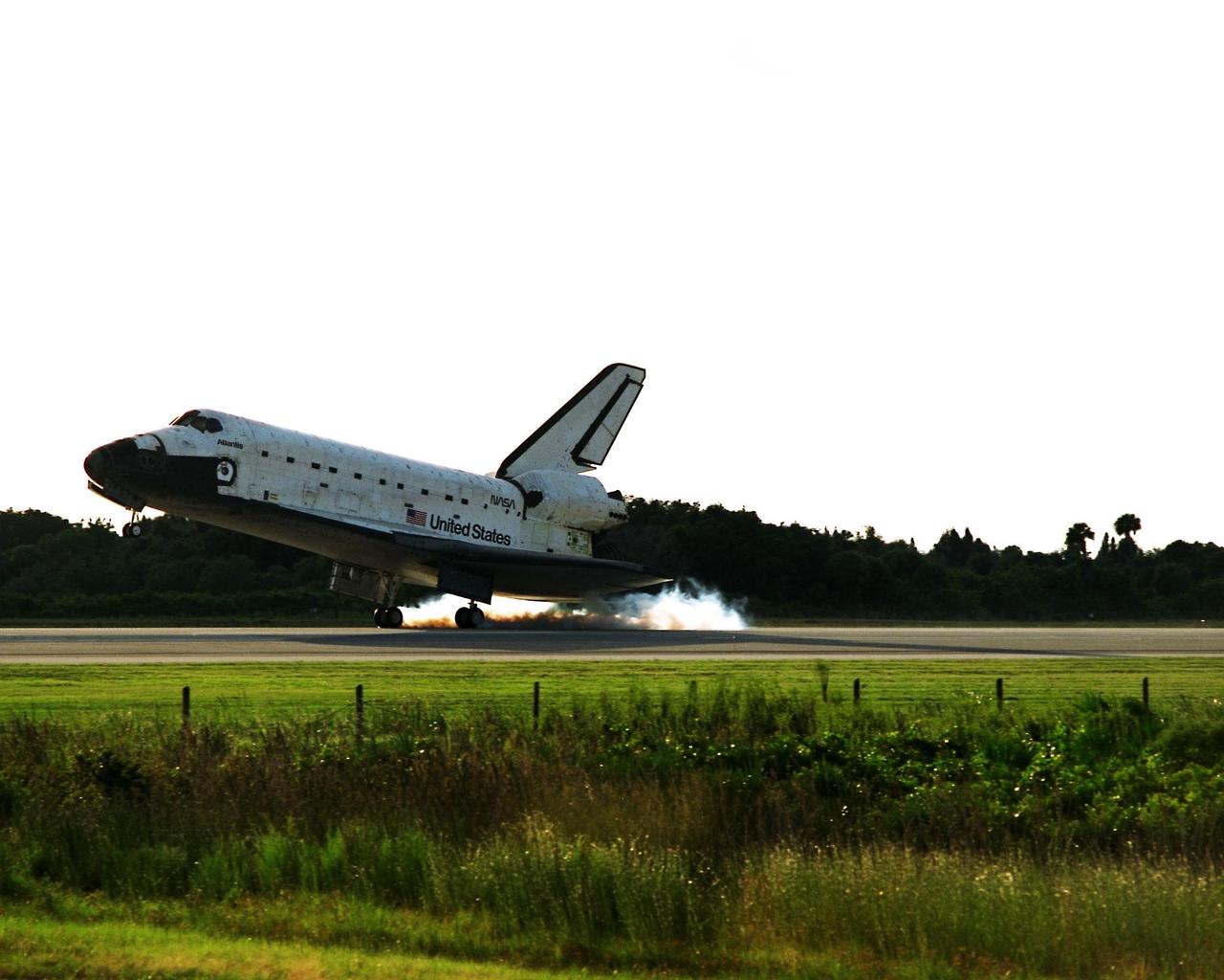 KENNEDY SPACE CENTER, Fla. -- The Space Shuttle orbiter Atlantis touches down on Runway 15 of the KSC Shuttle Landing Facility (SLF) to complete the nearly 11-day STS-86 mission. Main gear touchdown was at 5:55:09 p.m. EDT on Oct. 6, 1997. The unofficial mission-elapsed time at main gear touchdown was 10 days, 19 hours, 20 minutes and 50 seconds. The first two landing opportunities on Sunday were waved off because of weather concerns. The 87th Space Shuttle mission was the 40th landing of the Shuttle at KSC. On Sunday evening, the Space Shuttle program reached a milestone: The total flight time of the Shuttle passed the two-year mark. STS-86 was the seventh of nine planned dockings of the Space Shuttle with the Russian Space Station Mir. STS-86 Mission Specialist David A. Wolf replaced NASA astronaut and Mir 24 crew member C. Michael Foale, who has been on the Mir since mid-May. Foale returned to Earth on Atlantis with the remainder of the STS-86 crew. The other crew members are Commander James D. Wetherbee, Pilot Michael J. Bloomfield, and Mission Specialists Wendy B. Lawrence, Scott E. Parazynski, Vladimir Georgievich Titov of the Russian Space Agency, and Jean-Loup J.M. Chretien of the French Space Agency, CNES. Wolf is scheduled to remain on the Mir until the STS-89 Shuttle mission in January. Besides the docking and crew exchange, STS-86 included the transfer of more than three-and-ahalf tons of science/logistical equipment and supplies between the two orbiting spacecraft. Parazynski and Titov also conducted a spacewalk while Atlantis and the Mir were docked