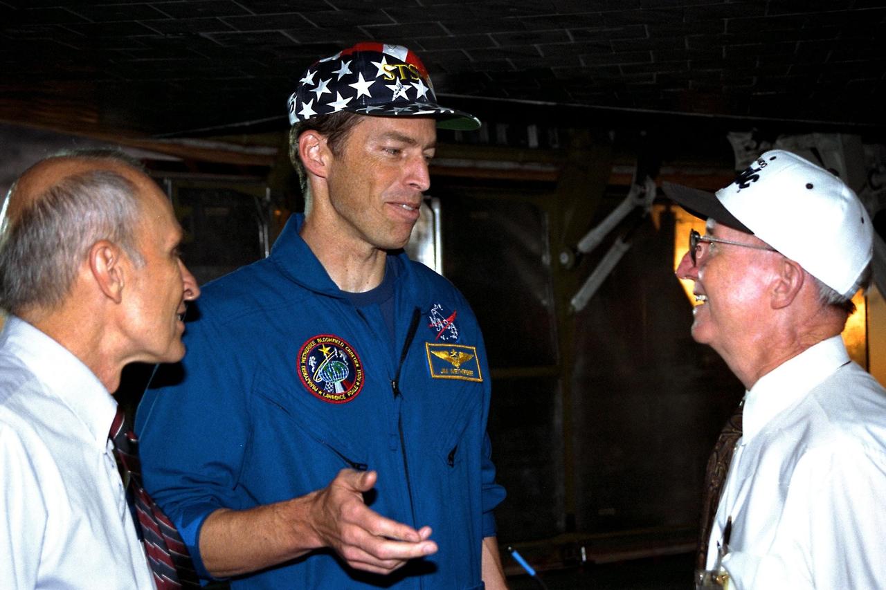 STS-86 Commander James D. Wetherbee, at center, is greeted by KSC Space Shuttle officials shortly after landing the orbiter Atlantis on KSC’s Runway 15. Shuttle Operations Director Bob Sieck is at left; Launch Director Jim Harrington is at Wetherbee’s right. The nearly 11-day mission ended with main gear touchdown at 5:55:09 p.m. EDT, Oct. 6, 1997. STS-86 was the seventh docking of the Space Shuttle with the Russian Space Station Mir