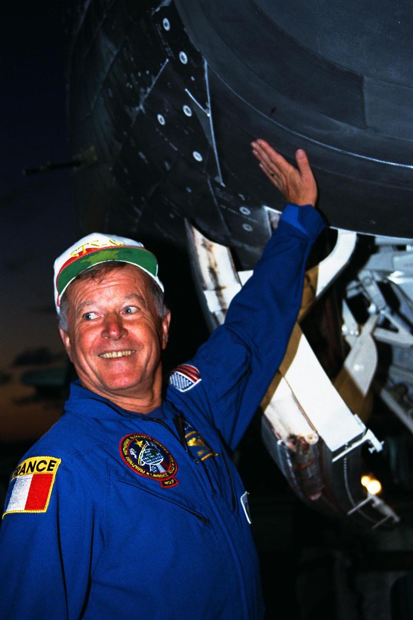 STS-86 Mission Specialist Jean-Loup J.M. Chretien of the French Space Agency, CNES, can still feel heat from the nose of the orbiter Atlantis more than an hour after landing on KSC’s Runway 15 of the Shuttle Landing Facility. The nearly 11-day mission ended with main gear touchdown at 5:55:09 p.m. EDT, Oct. 6, 1997. STS-86 was the seventh docking of the Space Shuttle with the Russian Space Station Mir
