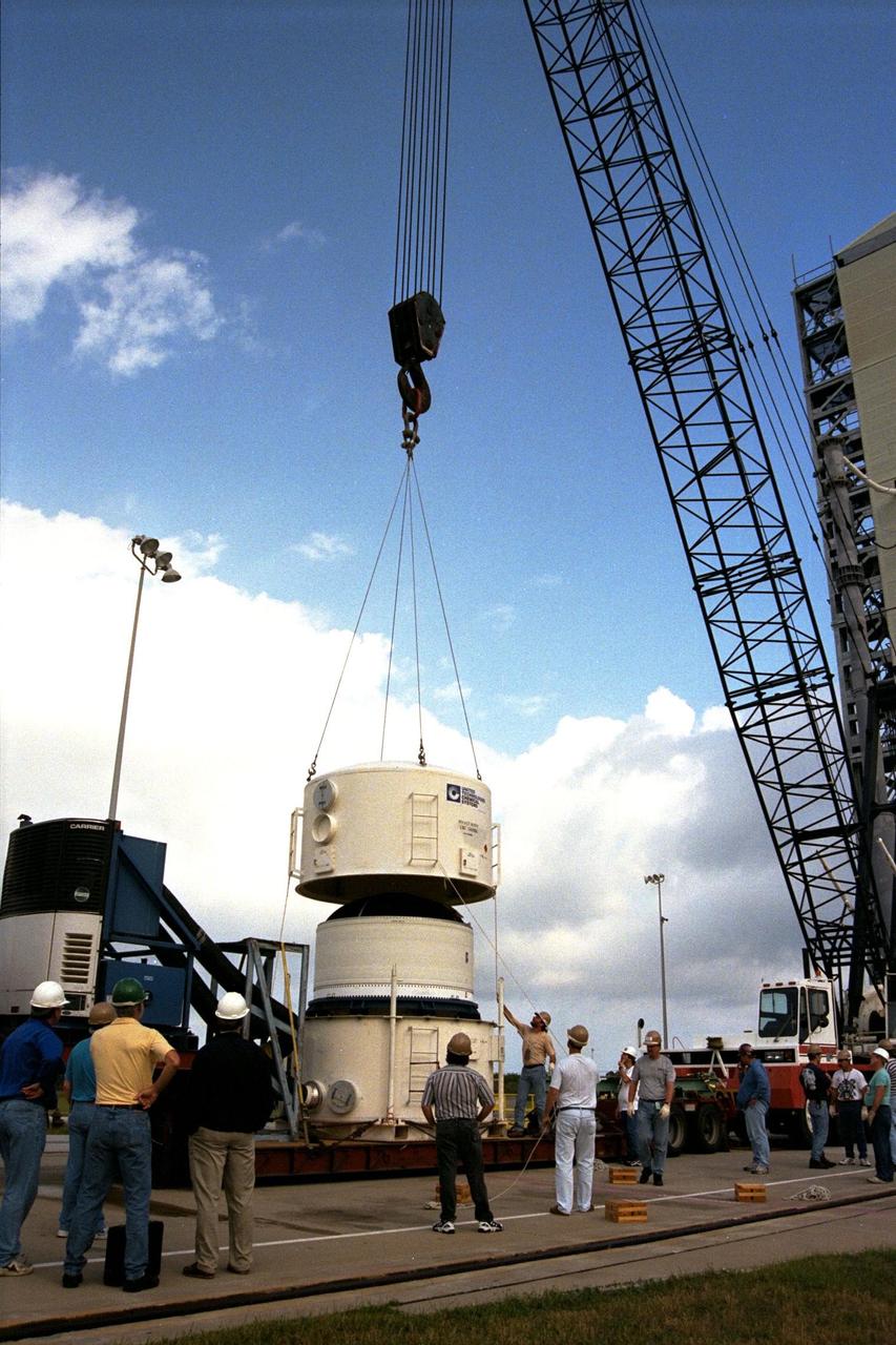 The third stage of the Lockheed Martin Athena launch vehicle arrives at Launch Complex 46 at Cape Canaveral Air Station before it is mated to the second stage. The protective covering for safe transportation is removed before the third stage is lifted on the launch pad. Athena is scheduled to carry the Lunar Prospector spacecraft for an 18-month mission that will orbit the Earth’s moon to collect data from the lunar surface. Scientific experiments to be conducted by the Prospector include locating water ice that may exist near the lunar poles, gathering data to understand the evolution of the lunar highland crust and the lunar magnetic field, finding radon outgassing events, and describing the lunar gravity field by means of Doppler tracking. The launch is now scheduled for early-January 1998