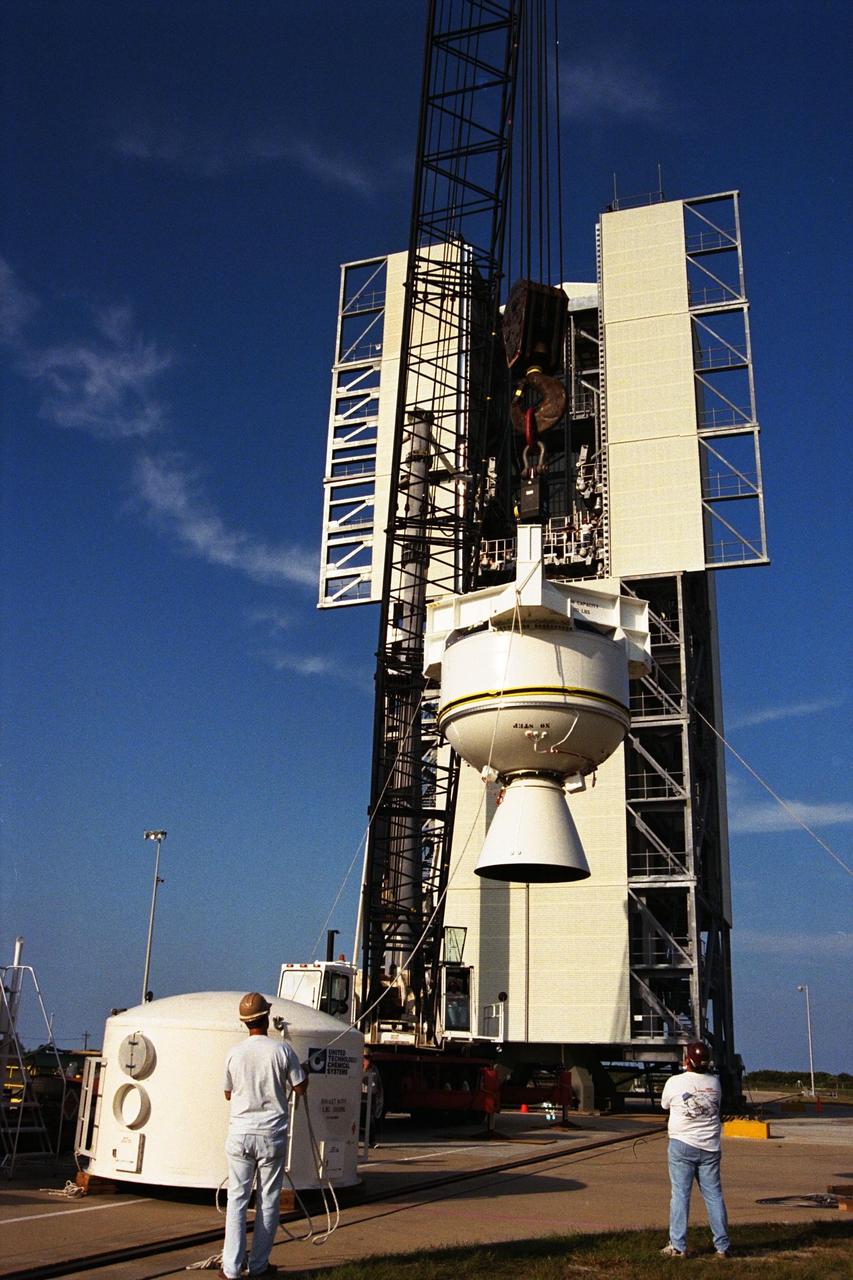 The third stage of the Lockheed Martin Athena launch vehicle is lifted at Launch Complex 46 at Cape Canaveral Air Station before mating to the second stage already on the pad. Athena is scheduled to carry the Lunar Prospector spacecraft for an 18-month mission that will orbit the Earth’s moon to collect data from the lunar surface. Scientific experiments to be conducted by the Prospector include locating water ice that may exist near the lunar poles, gathering data to understand the evolution of the lunar highland crust and the lunar magnetic field, finding radon outgassing events, and describing the lunar gravity field by means of Doppler tracking. The launch is now scheduled for early-January 1998