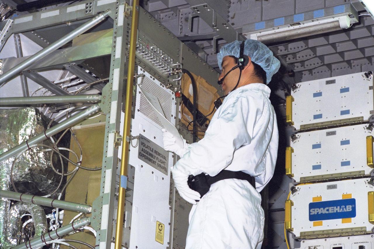 KENNEDY SPACE CENTER, FLA. -- A technician from the National Space Development Agency of Japan (NASDA) tests the real-time radiation monitoring device on SPACEHAB at Kennedy Space Center in preparation for the STS-89 mission, slated to be the first Shuttle launch of 1998. STS-89 will be the eighth of nine scheduled Mir dockings and will include a double module of SPACEHAB, used mainly as a large pressurized cargo container for science, logistical equipment and supplies to be exchanged between the orbiter Endeavour and the Russian Space Station Mir. The nine-day flight of STS-89 also is scheduled to include the transfer of the seventh American to live and work aboard the Russian orbiting outpost. Liftoff of Endeavour and its seven-member crew is targeted for Jan. 15, 1998, at 1:03 a.m. EDT from Launch Pad 39A