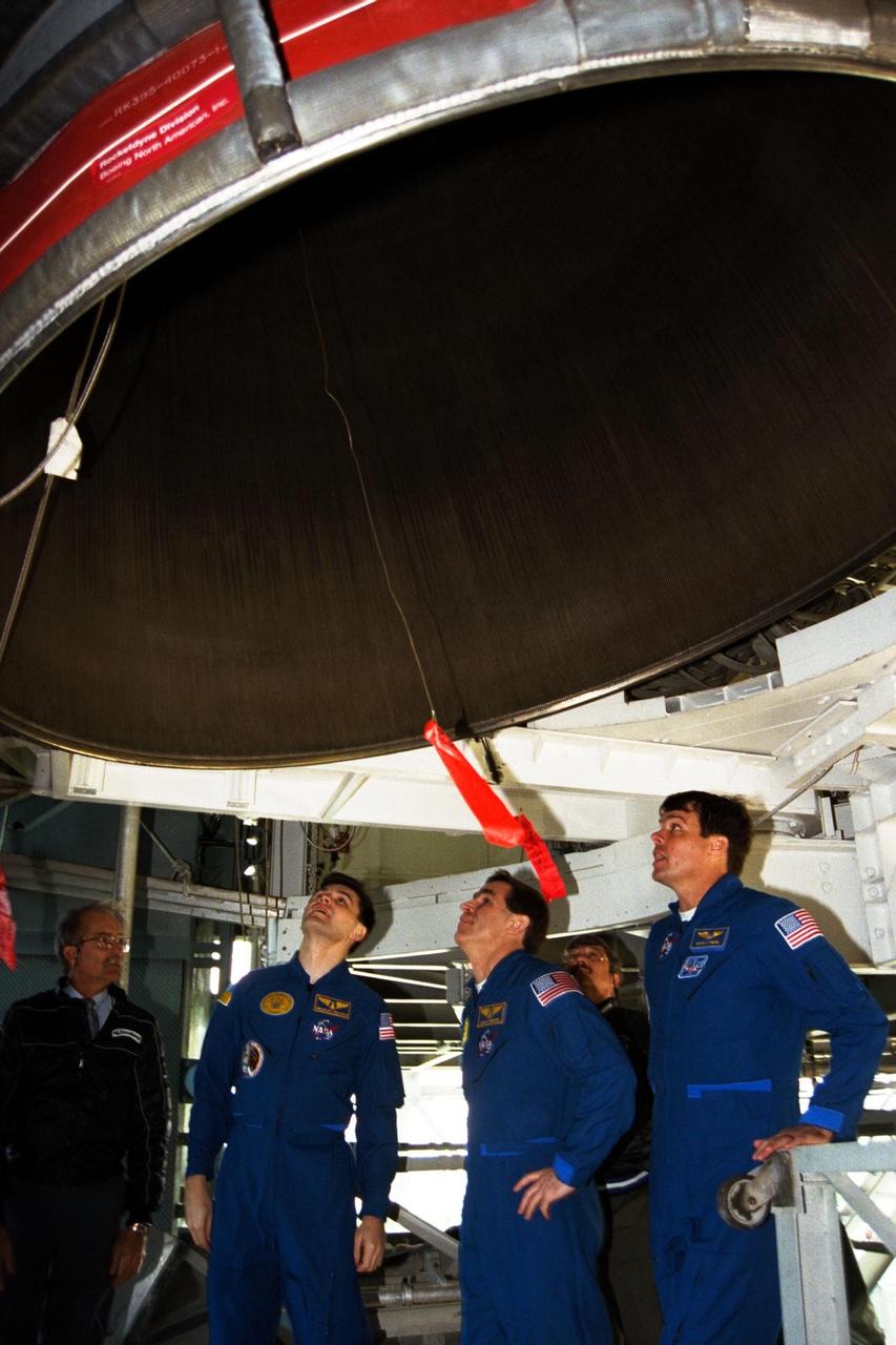 The crew of the STS-87 mission, scheduled for launch Nov. 19 aboard the Space Shuttle Columbia from Pad 39B at Kennedy Space Center (KSC), participates in the Terminal Countdown Demonstration Test (TCDT) at KSC. Getting a close look at one of the Space Shuttle’s main engines are, from right, Commander Kevin Kregel, Payload Specialist Leonid Kadenyuk of the National Space Agency of Ukraine (NSAU), and Kadenyuk’s back-up, Yaroslav Pustovyi, Ph.D., also of NSAU. The TCDT is held at KSC prior to each Space Shuttle flight, providing the crew of each mission opportunities to participate in simulated countdown activities. The TCDT ends with a mock launch countdown culminating in a simulated main engine cut-off. The crew also spends time undergoing emergency egress training exercises at the pad and has an opportunity to view and inspect the payloads in the orbiter's payload bay