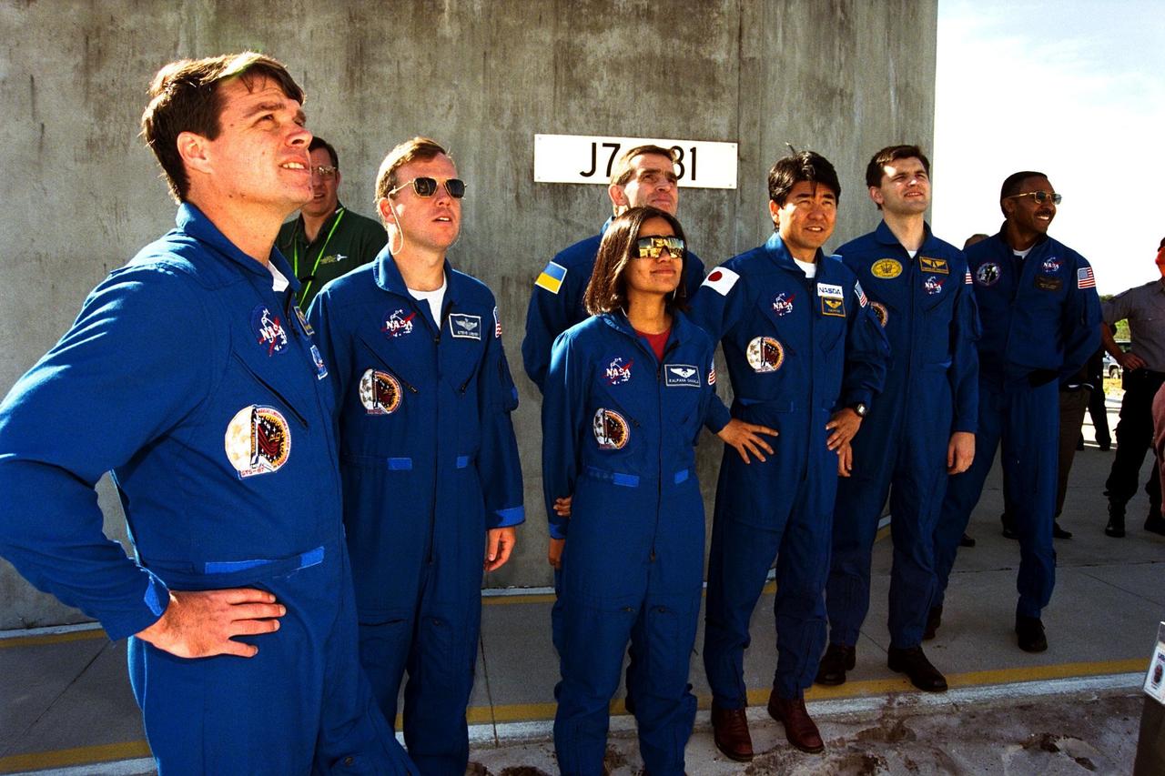 The crew of the STS-87 mission, scheduled for launch Nov. 19 aboard the Space Shuttle Columbia from Pad 39B at Kennedy Space Center (KSC), participates in the Terminal Countdown Demonstration Test (TCDT) at KSC. Getting a look at the Space Shuttle Columbia are, from left, Commander Kevin Kregel; Pilot Steven Lindsey; Mission Specialist Kalpana Chawla, Ph.D.; Payload Specialist Leonid Kadenyuk of the National Space Agency of Ukraine (NSAU); Mission Specialist Takao Doi, Ph.D., of the National Space Development Agency of Japan; Kadenyuk’s back-up, Yaroslav Pustovyi, Ph.D., also of NSAU; and Mission Specialist Winston Scott. The TCDT is held at KSC prior to each Space Shuttle flight providing the crew of each mission opportunities to participate in simulated countdown activities. The TCDT ends with a mock launch countdown culminating in a simulated main engine cut-off. The crew also spends time undergoing emergency egress training exercises at the pad and has an opportunity to view and inspect the payloads in the orbiter's payload bay