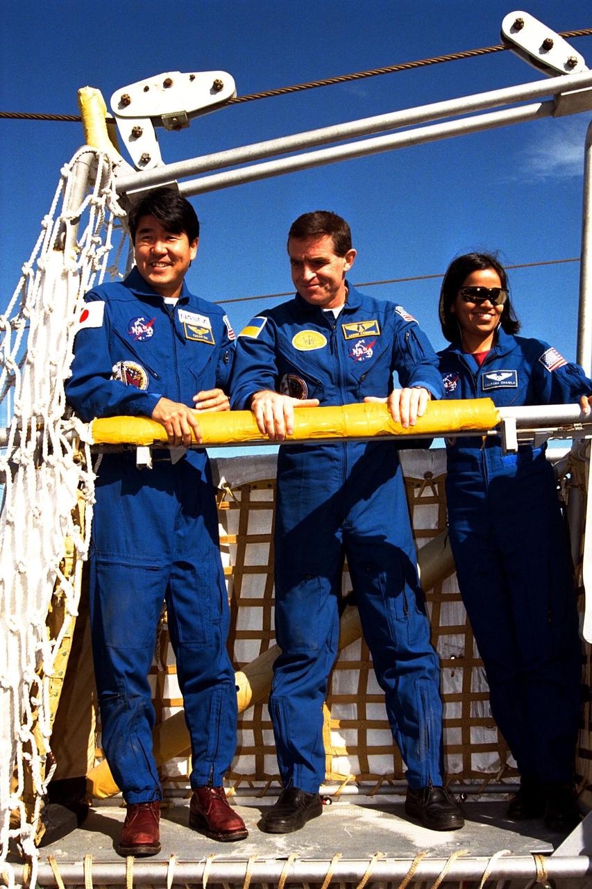 The crew of the STS-87 mission, scheduled for launch Nov. 19 aboard the Space Shuttle Columbia from pad 39B at Kennedy Space Center (KSC), participates in the Terminal Countdown Demonstration Test (TCDT) at KSC. Testing a slidewire basket that is part of the pad’s emergency egress system are, from left, Mission Specialist Takao Doi, Ph.D., of the National Space Development Agency of Japan; Payload Specialist Leonid Kadenyuk of the National Space Agency of Ukraine (NSAU); and Mission Specialist Kalpana Chawla, Ph.D. The TCDT is held at KSC prior to each Space Shuttle flight providing the crew of each mission opportunities to participate in simulated countdown activities. The TCDT ends with a mock launch countdown culminating in a simulated main engine cut-off. The crew also spends time undergoing emergency egress training exercises at the pad and has an opportunity to view and inspect the payloads in the orbiter's payload bay