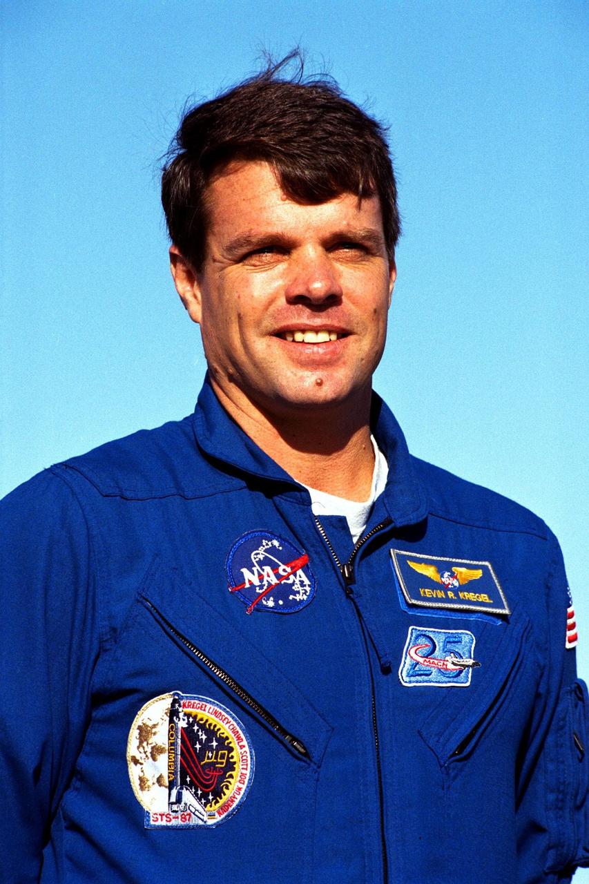 Kevin Kregel, commander of the STS-87 crew, participates in a news briefing at Launch Pad 39B during the Terminal Countdown Demonstration Test (TCDT) at Kennedy Space Center (KSC). Selected by NASA in 1992, Kregel is a veteran of two space flights (STS-70 and 78) and has logged over 618 hours in space. The TCDT is held at KSC prior to each Space Shuttle flight providing the crew of each mission opportunities to participate in simulated countdown activities. The TCDT ends with a mock launch countdown culminating in a simulated main engine cut-off. The crew also spends time undergoing emergency egress training exercises at the pad and has an opportunity to view and inspect the payloads in the orbiter's payload bay. STS-87 is scheduled for launch Nov. 19 aboard the Space Shuttle Columbia from pad 39B at KSC