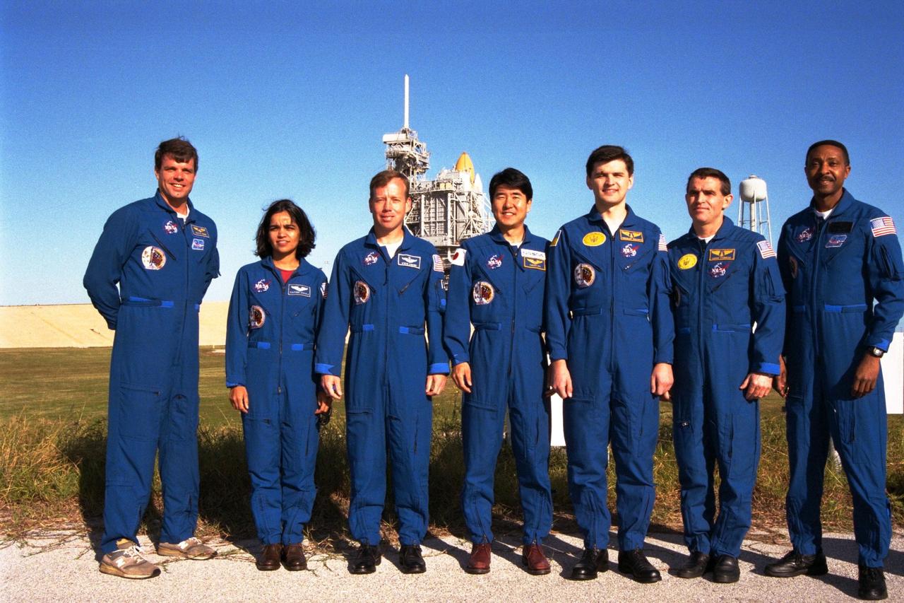 The crew of the STS-87 mission, scheduled for launch Nov. 19 aboard the Space Shuttle Columbia from Pad 39B at Kennedy Space Center (KSC), poses at the pad during a break in the Terminal Countdown Demonstration Test (TCDT) at KSC. Standing in front of the Shuttle Columbia are, from left, Commander Kevin Kregel; Mission Specialist Kalpana Chawla, Ph.D.; Pilot Steven Lindsey; Mission Specialist Takao Doi, Ph.D., of the National Space Development Agency of Japan; backup Payload Specialist Yaroslav Pustovyi, Ph.D., of the National Space Agency of Ukraine (NSAU); Payload Specialist Leonid Kadenyuk of NSAU; and Mission Specialist Winston Scott. The TCDT is held at KSC prior to each Space Shuttle flight providing the crew of each mission opportunities to participate in simulated countdown activities. The TCDT ends with a mock launch countdown culminating in a simulated main engine cutoff. The crew also spends time undergoing emergency egress training exercises at the pad and has an opportunity to view and inspect the payloads in the orbiter's payload bay