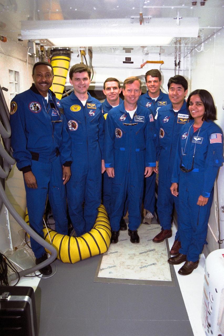 The crew of the STS-87 mission, scheduled for launch Nov. 19 aboard the Space Shuttle Columbia from pad 39B at Kennedy Space Center (KSC), participates in the Terminal Countdown Demonstration Test (TCDT) at KSC. Standing, from left, are Mission Specialist Winston Scott; backup Payload Specialist Yaroslav Pustovyi, Ph.D., of the National Space Agency of Ukraine (NSAU); Payload Specialist Leonid Kadenyuk of NSAU; Pilot Steven Lindsey; Commander Kevin Kregel; Mission Specialist Takao Doi, Ph.D., of the National Space Development Agency of Japan; and Mission Specialist Kalpana Chawla, Ph.D. The TCDT is held at KSC prior to each Space Shuttle flight providing the crew of each mission opportunities to participate in simulated countdown activities. The TCDT ends with a mock launch countdown culminating in a simulated main engine cut-off. The crew also spends time undergoing emergency egress training exercises at the pad and has an opportunity to view and inspect the payloads in the orbiter's payload bay