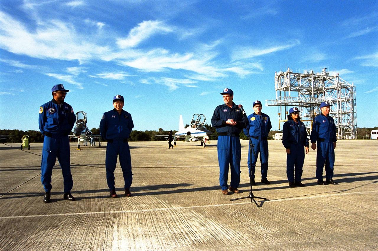 STS-87 Commander Kevin Kregel addresses members of the press and media at Kennedy Space Center's Shuttle Landing Facility after arriving for the final prelaunch activities leading up to the scheduled Nov. 19 liftoff. The STS-87 crew members are, from left to right, Mission Specialists Winston Scott and Takao Doi, Ph.D., of the National Space Development Agency of Japan; Commander Kevin Kregel; Payload Specialist Leonid Kadenyuk of the National Space Agency of Ukraine; Mission Specialist Kalpana Chawla, Ph.D.; and Pilot Steven Lindsey. STS-87 will be the fourth flight of the United States Microgravity Payload and the Spartan-201 deployable satellite