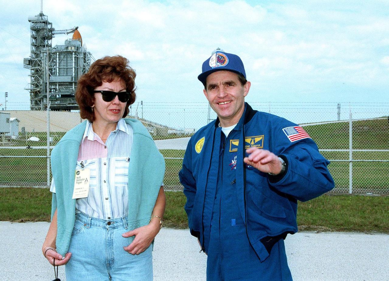 STS-87 Payload Specialist Leonid Kadenyuk of the National Space Agency of Ukraine poses with his wife, Vera Kadenyuk, in front of Kennedy Space Center's Launch Pad 39B during final prelaunch activities leading up to the scheduled Nov. 19 liftoff. The other STS-87 crew members are Commander Kevin Kregel; Pilot Steven Lindsey; and Mission Specialists Kalpana Chawla, Ph.D.; Winston Scott; and Takao Doi, Ph.D., National Space Development Agency of Japan. STS-87 will be the fourth flight of the United States Microgravity Payload and the Spartan-201 deployable satellite