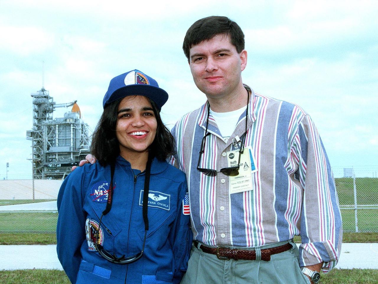 STS-87 Mission Specialist Kalpana Chawla, Ph.D., poses with her husband, Jean-Pierre Harrison, in front of Kennedy Space Center's Launch Pad 39B during final prelaunch activities leading up to the scheduled Nov. 19 liftoff. The other STS-87 crew members are Commander Kevin Kregel; Pilot Steven Lindsey; Mission Specialists Winston Scott and Takao Doi, Ph.D., of the National Space Development Agency of Japan; and Payload Specialist Leonid Kadenyuk of the National Space Agency of Ukraine. STS-87 will be the fourth flight of the United States Microgravity Payload and the Spartan-201 deployable satellite