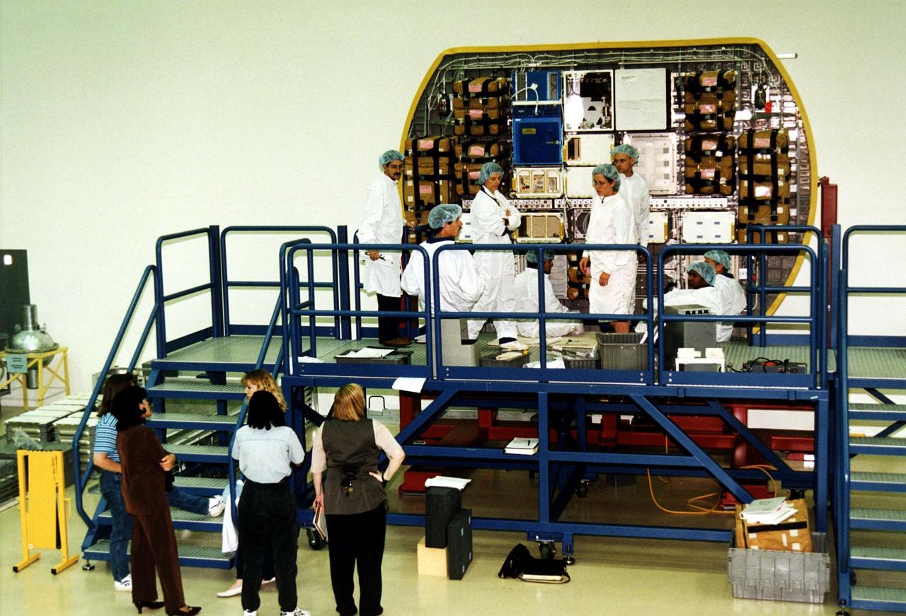 KENNEDY SPACE CENTER, FLA. -- STS-89 crew members and technicians participate in the Crew Equipment Interface Test (CEIT) in front of the back cap of the SPACEHAB module at the SPACEHAB Payload Processing Facility at Port Canaveral in preparation for the mission, slated to be the first Shuttle launch of 1998. The CEIT gives astronauts an opportunity to get a hands-on look at the payloads with which they will be working onorbit. STS-89 will be the eighth of nine scheduled Mir dockings and will include a double module of SPACEHAB, used mainly as a large pressurized cargo container for science, logistical equipment and supplies to be exchanged between the orbiter Endeavour and the Russian Space Station Mir. The nine-day flight of STS-89 also is scheduled to include the transfer of the seventh American to live and work aboard the Russian orbiting outpost. Liftoff of Endeavour and its seven-member crew is targeted for Jan. 15, 1998, at 1:03 a.m. EDT from Launch Pad 39A