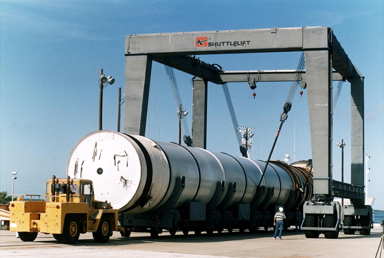 A spent solid rocket booster (SRB) from the STS-87 launch on Nov. 19 is lifted in a hoisting slip in the Hangar AF area at Cape Canaveral Air Station. Hangar AF is a building originally used for Project Mercury, the first U.S. manned space program. The SRBs are the largest solid propellant motors ever flown and the first designed for reuse. After a Shuttle is launched, the SRBs are jettisoned at two minutes, seven seconds into the flight. At six minutes and 44 seconds after liftoff, the spent SRBs, weighing about 165,000 lb., have slowed their descent speed to about 62 mph and splashdown takes place in a predetermined area. They are retrieved from the Atlantic Ocean by special recovery vessels and returned for refurbishment and eventual reuse on future Shuttle flights. Once at Hangar AF, the SRBs are unloaded onto a hoisting slip and mobile gantry cranes lift them onto tracked dollies where they are safed and undergo their first washing