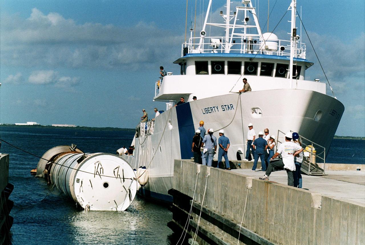 KENNEDY SPACE CENTER, FLA. -- Seen carrying a spent solid rocket booster (SRB) from the STS-87 launch on Nov. 19 is the solid rocket booster recovery ship Liberty Star as it reenters the Hangar AF area at Cape Canaveral Air Station. Hangar AF is a building originally used for Project Mercury, the first U.S. manned space program. The SRBs are the largest solid propellant motors ever flown and the first designed for reuse. After a Shuttle is launched, the SRBs are jettisoned at two minutes, seven seconds into the flight. At six minutes and 44 seconds after liftoff, the spent SRBs, weighing about 165,000 lb., have slowed their descent speed to about 62 mph and splashdown takes place in a predetermined area. They are retrieved from the Atlantic Ocean by special recovery vessels and returned for refurbishment and eventual reuse on future Shuttle flights. Once at Hangar AF, the SRBs are unloaded onto a hoisting slip and mobile gantry cranes lift them onto tracked dollies where they are safed and undergo their first washing