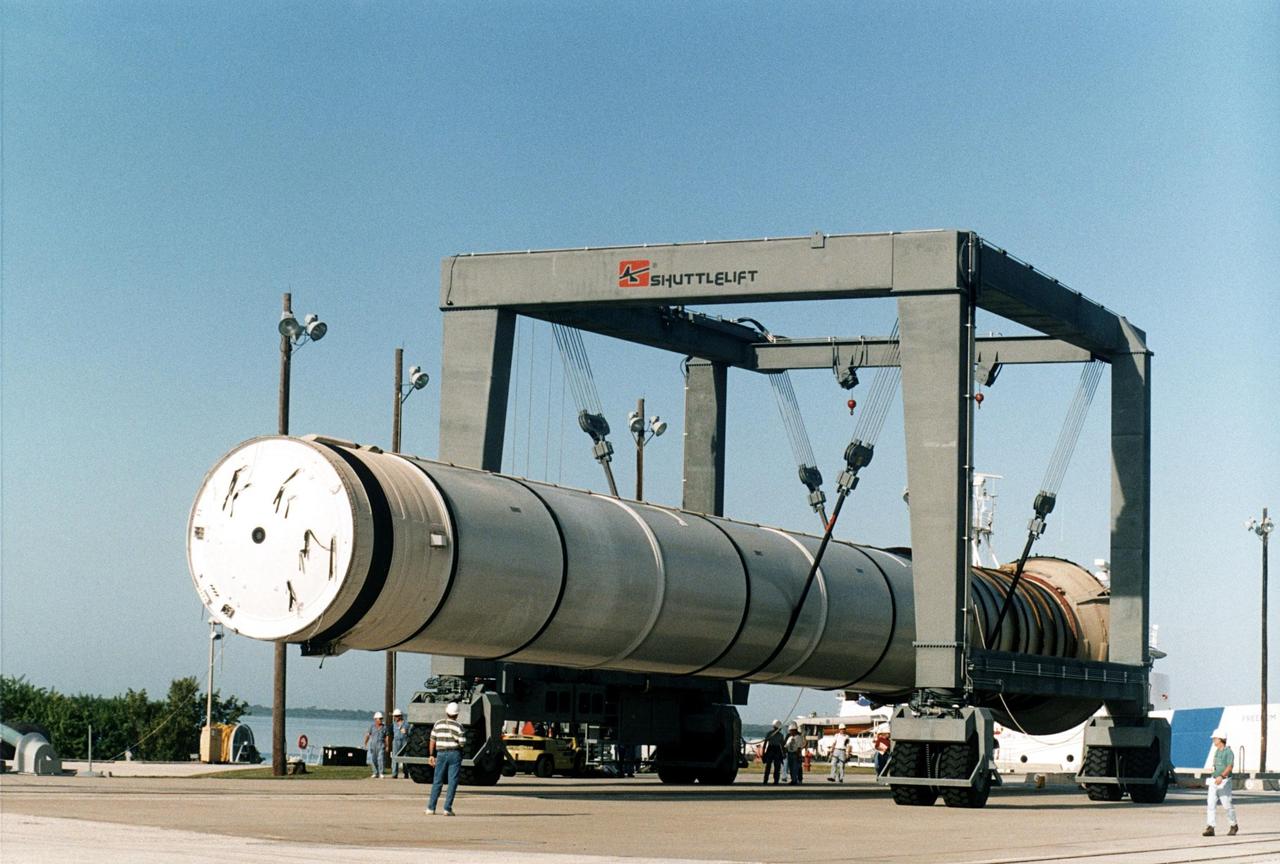 A spent solid rocket booster (SRB) from the STS-87 launch on Nov. 19 is lifted in a hoisting slip in the Hangar AF area at Cape Canaveral Air Station. Hangar AF is a building originally used for Project Mercury, the first U.S. manned space program. The SRBs are the largest solid propellant motors ever flown and the first designed for reuse. After a Shuttle is launched, the SRBs are jettisoned at two minutes, seven seconds into the flight. At six minutes and 44 seconds after liftoff, the spent SRBs, weighing about 165,000 lb., have slowed their descent speed to about 62 mph and splashdown takes place in a predetermined area. They are retrieved from the Atlantic Ocean by special recovery vessels and returned for refurbishment and eventual reuse on future Shuttle flights. Once at Hangar AF, the SRBs are unloaded onto a hoisting slip and mobile gantry cranes lift them onto tracked dollies where they are safed and undergo their first washing