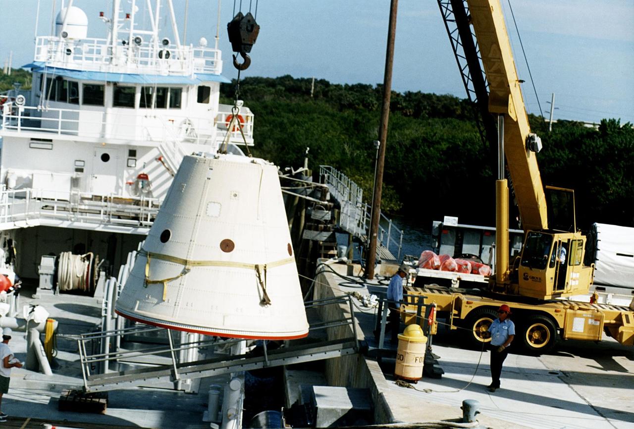 KENNEDY SPACE CENTER, FLA. -- The frustum of a forward skirt assembly of a spent solid rocket booster (SRB) from the STS-87 launch on Nov. 19 is transported into the Hangar AF area at Cape Canaveral Air Station. Hangar AF is a building originally used for Project Mercury, the first U.S. manned space program. The SRBs are the largest solid propellant motors ever flown and the first designed for reuse. After a Shuttle is launched, the SRBs are jettisoned at two minutes, seven seconds into the flight. At six minutes and 44 seconds after liftoff, the spent SRBs, weighing about 165,000 lb., have slowed their descent speed to about 62 mph and splashdown takes place in a predetermined area. They are retrieved from the Atlantic Ocean by special recovery vessels and returned for refurbishment and eventual reuse on future Shuttle flights. Once at Hangar AF, the SRBs are unloaded onto a hoisting slip and mobile gantry cranes lift them onto tracked dollies where they are safed and undergo their first washing