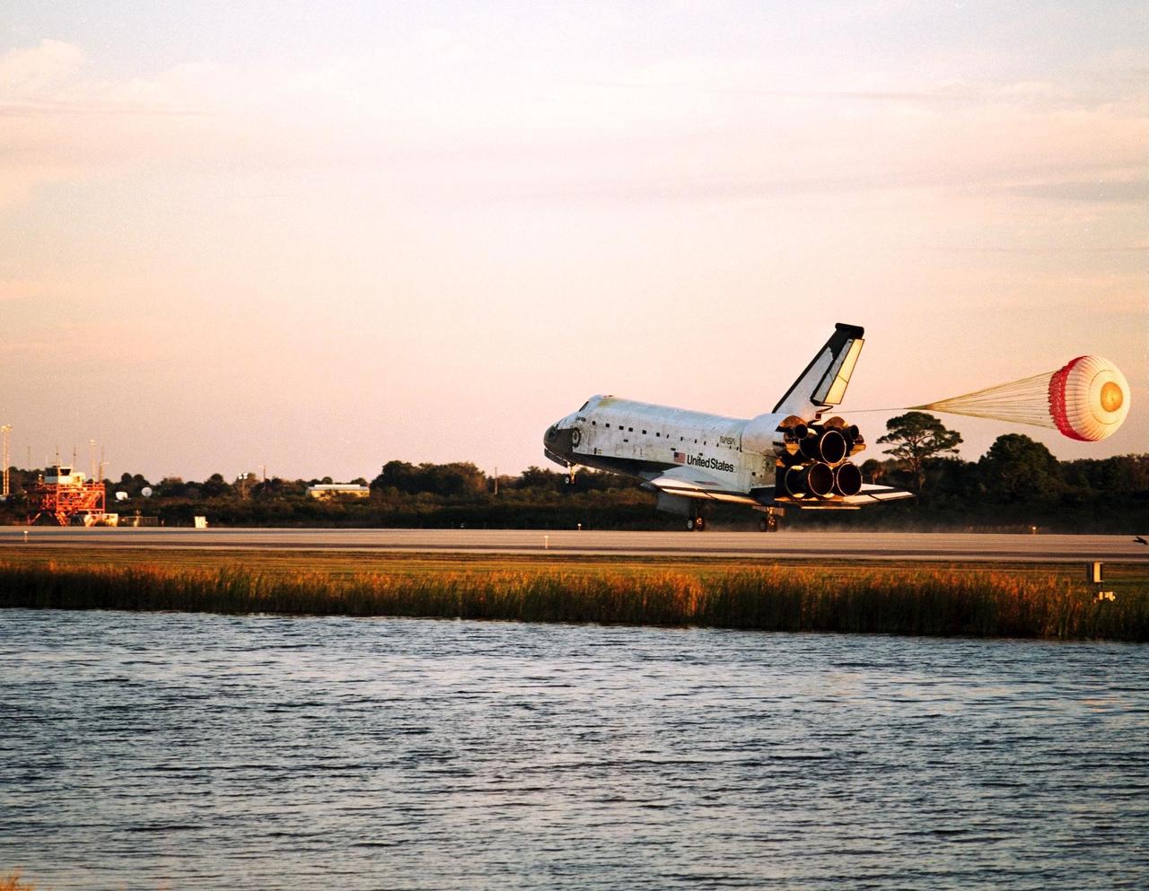 With Commander Kevin Kregel and Pilot Steven Lindsey at the controls, the orbiter Columbia, with its drag chute deployed, touches its main gear down on Runway 33 at KSC’s Shuttle Landing Facility at 7:20:04 a.m. EST Dec. 5 to complete the 15-day, 16-hour and 34-minute-long STS-87 mission of 6.5 million miles. Also onboard the orbiter are Mission Specialists Winston Scott; Kalpana Chawla, Ph.D.; and Takao Doi, Ph.D., of the National Space Development Agency of Japan; along with Payload Specialist Leonid Kadenyuk of the National Space Agency of Ukraine. During the 88th Space Shuttle mission, the crew performed experiments on the United States Microgravity Payload-4 and pollinated plants as part of the Collaborative Ukrainian Experiment. This was the 12th landing for Columbia at KSC and the 41st KSC landing in the history of the Space Shuttle program