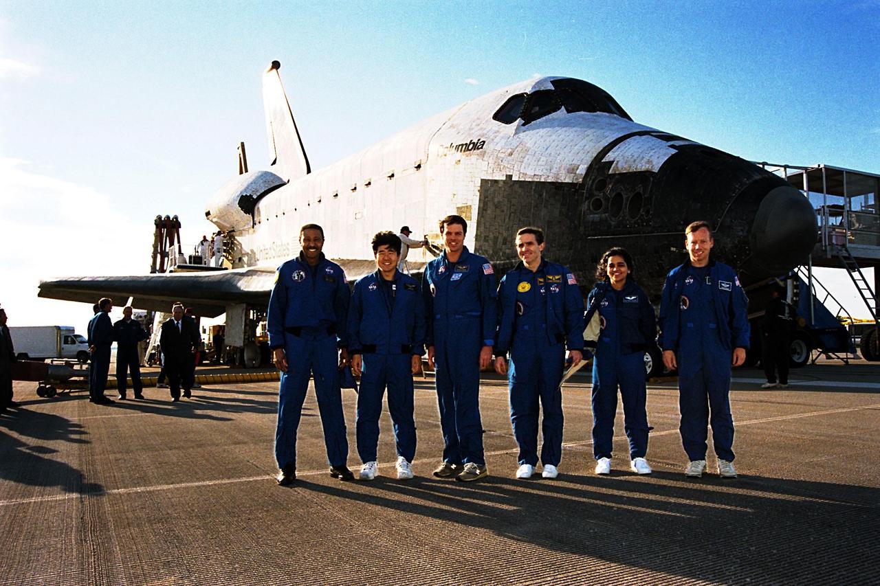 The STS-87 crew pose in front of the orbiter Columbia shortly after landing on Runway 33 at KSC's Shuttle Landing Facility. STS-87 concluded its mission with a main gear touchdown at 7:20:04 a.m. EST Dec. 5, drawing the 15-day, 16-hour and 34-minute-long mission of 6.5 million miles to a close. From left to right are Mission Specialists Winston Scott and Takao Doi, Ph.D., of the National Space Development Agency of Japan; Commander Kevin Kregel; Payload Specialist Leonid Kadenyuk of the National Space Agency of Ukraine; Mission Specialist Kalpana Chawla, Ph.D.; and Pilot Steven Lindsey. During the 88th Space Shuttle mission, the crew performed experiments on the United States Microgravity Payload-4 and pollinated plants as part of the Collaborative Ukrainian Experiment. This was the 12th landing for Columbia at KSC and the 41st KSC landing in the history of the Space Shuttle program