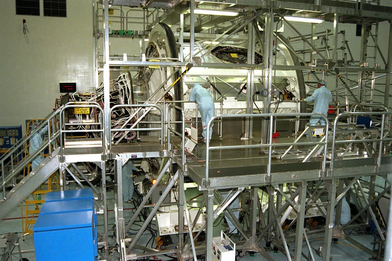 KENNEDY SPACE CENTER, FLA. -- The International Space Station's Node 1 and Pressurized Mating Adapter-1 (PMA-1) are rotated by workers in KSC's Space Station Processing Facility. The node is rotated to provide access to different areas of the flight element for processing. Here, the node is rotated to provide access for the installation of heat pipe radiators and a flight computer. The node is scheduled to launch into space on STS-88, slated for a July 9 liftoff at 1:11 p.m. from KSC's Launch Pad 39B