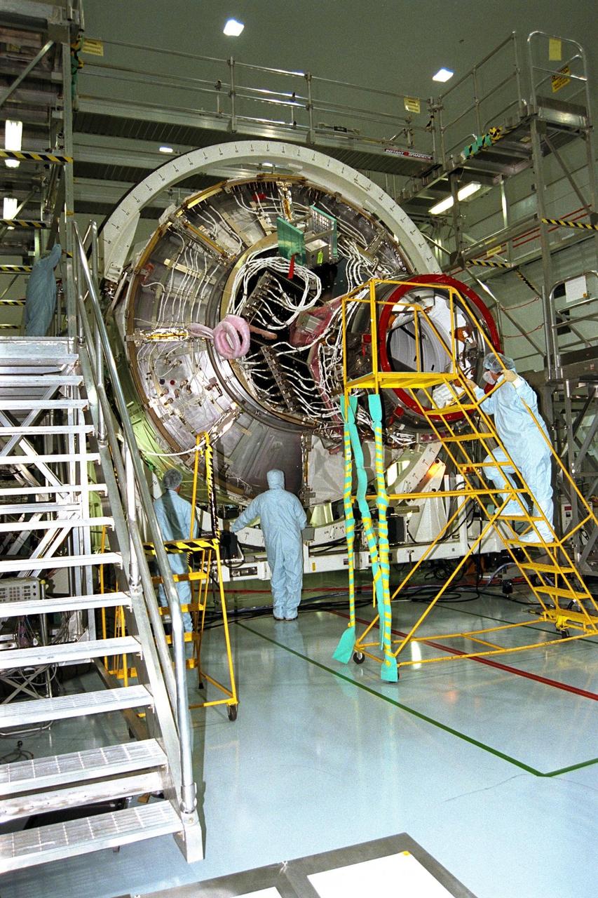 KENNEDY SPACE CENTER, FLA. -- The International Space Station's Node 1 and Pressurized Mating Adapter-1 (PMA-1) are rotated by workers in KSC's Space Station Processing Facility. The node is rotated to provide access to different areas of the flight element for processing. Here, the node is rotated to provide access for the installation of heat pipe radiators and a flight computer. The node is scheduled to launch into space on STS-88, slated for a July 9 liftoff at 1:11 p.m. from KSC's Launch Pad 39B.