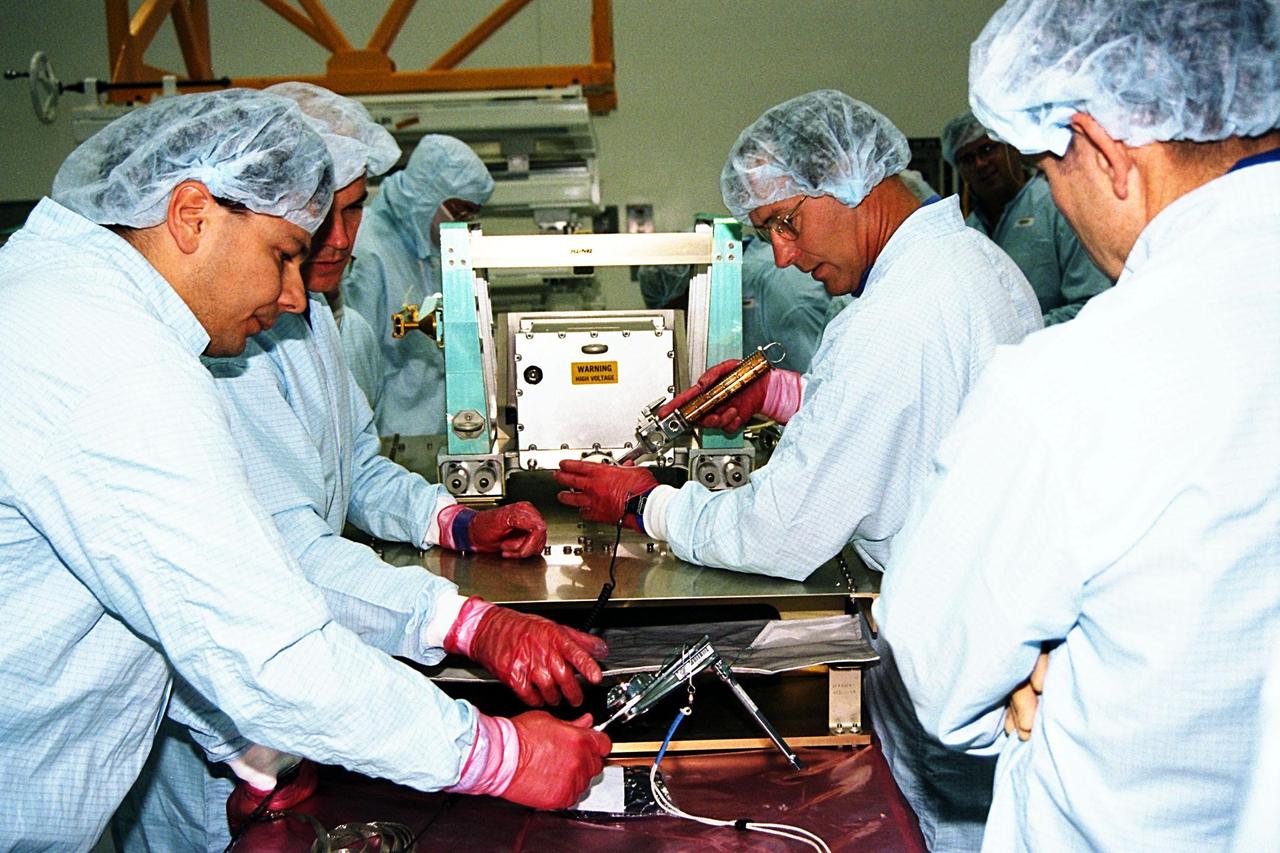 STS-88 crew members participate in the Crew Equipment Interface Test (CEIT) in KSC's Space Station Processing Facility. Working on a high voltage box for electrical connections for the International Space Station (ISS) are, left to right, a technician, Pilot Rick Sturckow, Mission Specialist Jerry Ross (with glasses), and Commander Bob Cabana (back to camera). The CEIT gives astronauts an opportunity to get a hands-on look at the payloads with which they will be working on-orbit. STS-88, the first ISS assembly flight, is targeted for launch in July 1998 aboard Space Shuttle Endeavour