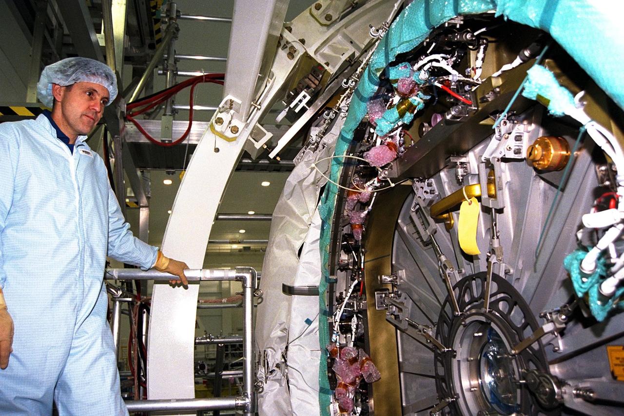 Commander Bob Cabana participates in the Crew Equipment Interface Test (CEIT) for STS-88 in KSC's Space Station Processing Facility. The CEIT gives astronauts an opportunity to get a hands-on look at the payloads with which they will be working on-orbit. Here, Cabana inspects one of the six hatches on Node 1 of the International Space Station (ISS). STS-88, the first ISS assembly flight, is targeted for launch in July 1998 aboard Space Shuttle Endeavour