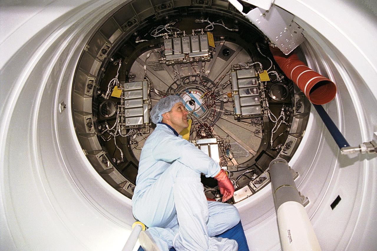 KENNEDY SPACE CENTER, FLA. -- Commander Bob Cabana participates in the Crew Equipment Interface Test (CEIT) for STS-88 in KSC's Space Station Processing Facility. The CEIT gives astronauts an opportunity to get a hands-on look at the payloads with which they will be working on-orbit. Here, Cabana sits inside the Pressurized Mating Adapter-1 (PMA-1) for a close-up look at some of the connecting ducts and wires. Node 1 of the International Space Station (ISS) is behind him. STS-88, the first ISS assembly flight, is targeted for launch in July 1998 aboard Space Shuttle Endeavour