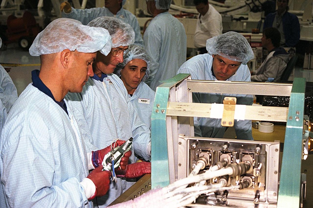 STS-88 crew members participate in the Crew Equipment Interface Test (CEIT) for that mission in KSC's Space Station Processing Facility. Discussing the mission are, from left to right, Pilot Rick Sturckow, Mission Specialists Jerry Ross and Nancy Currie, and Commander Bob Cabana. The CEIT gives astronauts an opportunity to get a hands-on look at the payloads with which they will be working on-orbit. STS-88, the first ISS assembly flight, is targeted for launch in July 1998 aboard Space Shuttle Endeavour