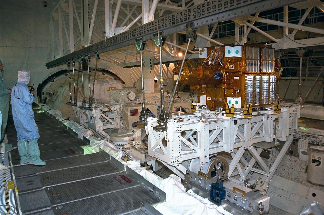 The Spartan payload, which flew on STS-87, is removed from Columbia's cargo bay in Orbiter Processing Facility Bay 3 and will be transported to the Vertical Processing Facility