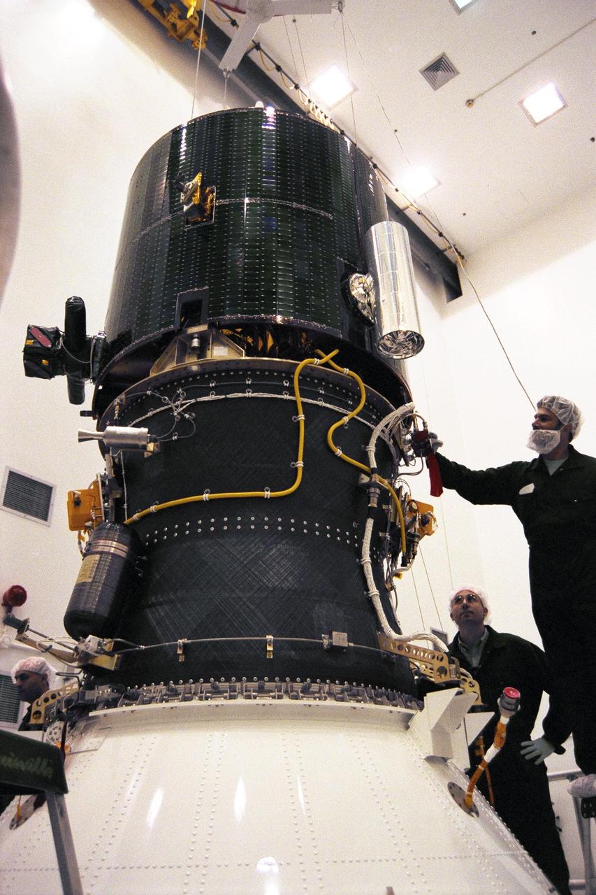 Lockheed Martin Missile Systems integration and test staff join NASA’s Lunar Prospector spacecraft atop the Trans Lunar Injection Module of the spacecraft at Astrotech, a commercial payload processing facility, in Titusville, Fla. The small robotic spacecraft, to be launched on an Athena II launch vehicle by Lockheed Martin, is designed to provide the first global maps of the Moon’s surface compositional elements and its gravitational and magnetic fields. The launch of Lunar Prospector is scheduled for Jan. 5, 1998 at 8:31 p.m
