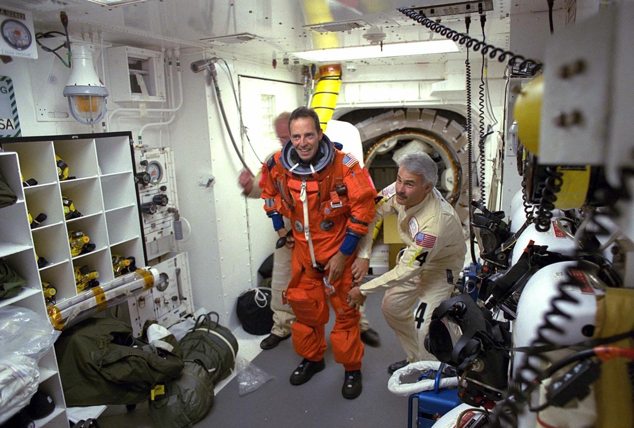 STS-84 Mission Specialist Jean-Francois Clervoy prepares to enter the Space Shuttle Atlantis at Launch Pad 39A with help from white room closeout crew members. The fourth Shuttle mission of 1997 will be the sixth docking of the Space Shuttle with the Russian Space Station Mir. The commander is Charles J. Precourt. The pilot is Eileen Marie Collins. The five mission specialists are C. Michael Foale, Carlos I. Noriega, Edward Tsang Lu, Jean-Francois Clervoy of the European Space Agency and Elena V. Kondakova of the Russian Space Agency. The planned nine-day mission will include the exchange of Foale for U.S. astronaut and Mir 23 crew member Jerry M. Linenger, who has been on Mir since Jan. 15. Linenger transferred to Mir during the last docking mission, STS-81; he will return to Earth on Atlantis. Foale is slated to remain on Mir for about four months until he is replaced in September by STS-86 Mission Specialist Wendy B. Lawrence. During the five days Atlantis is scheduled to be docked with the Mir, the STS-84 crew and the Mir 23 crew, including two Russian cosmonauts, Commander Vasily Tsibliev and Flight Engineer Alexander Lazutkin, will participate in joint experiments. The STS-84 mission also will involve the transfer of more than 7,300 pounds of water, logistics and science equipment to and from the Mir. Atlantis is carrying a nearly 300-pound oxygen generator to replace one of two Mir units which have experienced malfunctions. The oxygen it generates is used for breathing by the Mir crew
