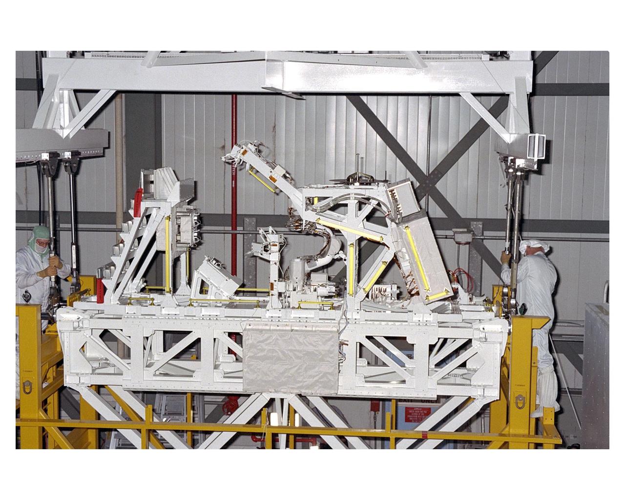 The Manipulator Flight Demonstration (MFD) payload is prepared for hoisting and installation into the payload bay of the Space Shuttle Orbiter Discovery in Orbiter Processing Facility 2. The MFD is one of several payloads that will fly on the STS-85 mission. This payload is designed to test the operational capability of the Japanese Experiment Module Remote Manipulator System (JEM RMS) Small Fine Arm (SFA), which can be seen atop its Multi-Purpose Experiment Support Structure (MPESS) carrier that will serve as a platform in the payload bay for the robotic arm experiment. The arm, which will be a part of the JEM element of the International Space Station, will be operated from the orbiter’s aft flight deck during the 11-day mission. Other payloads that will be aboard Discovery on this space flight include the  Cryogenic Infrared Spectrometers and Telescopes for the Atmosphere-Shuttle Pallet Satellite-2 (CRISTA-SPAS-2), Technology Applications and Science-1 (TAS-1) and International Extreme Ultraviolet Hitchhiker (IEH-2) experiments