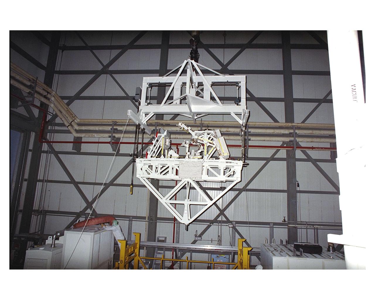 The Manipulator Flight Demonstration (MFD) payload is hoisted for installation into the payload bay of the Space Shuttle Orbiter Discovery in Orbiter Processing Facility 2. The MFD is one of several payloads that will fly on the STS-85 mission. This payload is designed to test the operational capability of the Japanese Experiment Module Remote Manipulator System (JEM RMS) Small Fine Arm (SFA), which can be seen atop its Multi-Purpose Experiment Support Structure (MPESS) carrier that will serve as a platform in the payload bay for the robotic arm experiment. The arm, which will be a part of the JEM element of the International Space Station, will be operated from the orbiter’s aft flight deck during the 11-day mission. Other payloads that will be aboard Discovery on this space flight include the  Cryogenic Infrared Spectrometers and Telescopes for the Atmosphere-Shuttle Pallet Satellite-2 (CRISTA-SPAS-2), Technology Applications and Science-1 (TAS-1) and International Extreme Ultraviolet Hitchhiker (IEH-2) experiments