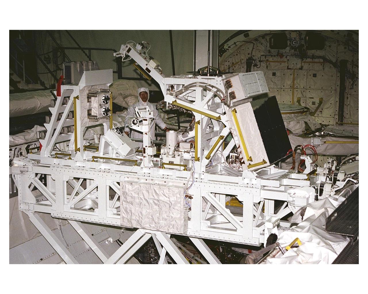 The Manipulator Flight Demonstration (MFD) payload is installed into the payload bay of the Space Shuttle Orbiter Discovery in Orbiter Processing Facility 2. The MFD is one of several payloads that will fly on the STS-85 mission. This payload is designed to test the operational capability of the Japanese Experiment Module Remote Manipulator System (JEM RMS) Small Fine Arm (SFA), which can be seen atop its Multi-Purpose Experiment Support Structure (MPESS) carrier that will serve as a platform in the payload bay for the robotic arm experiment. The arm, which will be a part of the JEM element of the International Space Station, will be operated from the orbiter’s aft flight deck during the 11-day mission. Other payloads that will be aboard Discovery on this space flight include the  Cryogenic Infrared Spectrometers and Telescopes for the Atmosphere-Shuttle Pallet Satellite-2 (CRISTA- SPAS-2),  Technology Applications and Science-1 (TAS-1) and International Extreme Ultraviolet Hitchhiker (IEH-2) experiments