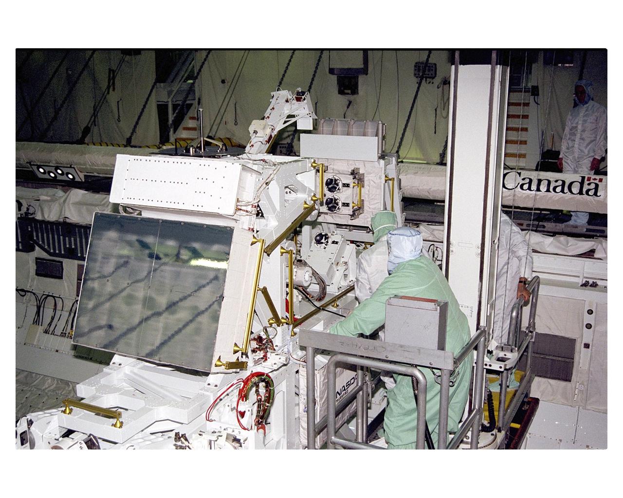 The Manipulator Flight Demonstration (MFD) payload is installed into the payload bay of the Space Shuttle Orbiter Discovery in Orbiter Processing Facility 2. The MFD is one of several payloads that will fly on the STS-85 mission. This payload is designed to test the operational capability of the Japanese Experiment Module Remote Manipulator System (JEM RMS) Small Fine Arm (SFA), which can be seen atop its Multi-Purpose Experiment Support Structure (MPESS) carrier that will serve as a platform in the payload bay for the robotic arm experiment. The arm, which will be a part of the JEM element of the International Space Station, will be operated from the orbiter’s aft flight deck during the 11-day mission. Other payloads that will be aboard Discovery on this space flight include the  Cryogenic Infrared Spectrometers and Telescopes for the Atmosphere-Shuttle Pallet Satellite-2 (CRISTA- SPAS-2),  Technology Applications and Science-1 (TAS-1) and International Extreme Ultraviolet Hitchhiker (IEH-2) experiments