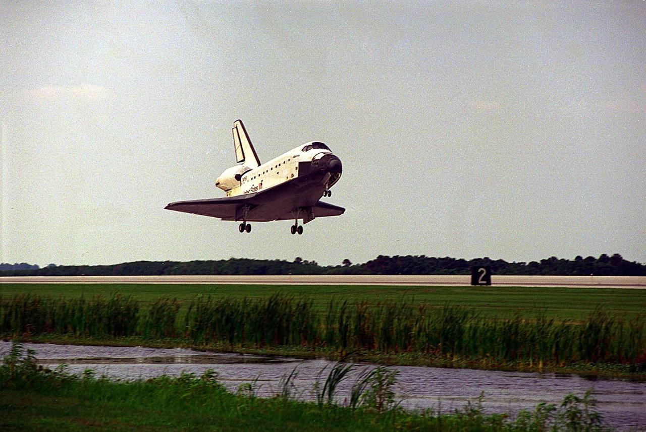 The Space Shuttle orbiter Atlantis glides in for a landing on Runway 33 at KSC’s Shuttle Landing Facility at the conclusion of the nine-day STS-84 mission. It will be the 37th landing at KSC since the Shuttle program began in 1981, and the eighth consecutive landing at KSC. STS-84 was the sixth of nine planned dockings of the Space Shuttle with the Russian Space Station Mir. Atlantis was docked with the Mir for five days. STS-84 Mission Specialist C. Michael Foale replaced astronaut and Mir 23 crew member Jerry M. Linenger, who has been on the Russian space station since Jan. 15. Linenger returned to Earth on Atlantis with the rest of the STS-84 crew, Mission Commander Charles J. Precourt, Pilot Eileen Marie Collins, and Mission Specialists Carlos I. Noriega, Edward Tsang Lu, Elena V. Kondakova of the Russian Space Agency and Jean-Francois Clervoy of the European Space Agency. Foale is scheduled to remain on the Mir for approximately four months, until he is replaced by STS-86 crew member Wendy B. Lawrence in September. Besides the docking and crew exchange, STS-84 included the transfer of more than 7,300 pounds of water, logistics and science experiments and hardware to and from the Mir. Scientific experiments conducted during the STS-84 mission, and scheduled for Foale’s stay on the Mir, are in the fields of advanced technology, Earth sciences, fundamental biology, human life sciences, International Space Station risk mitigation, microgravity sciences and space sciences